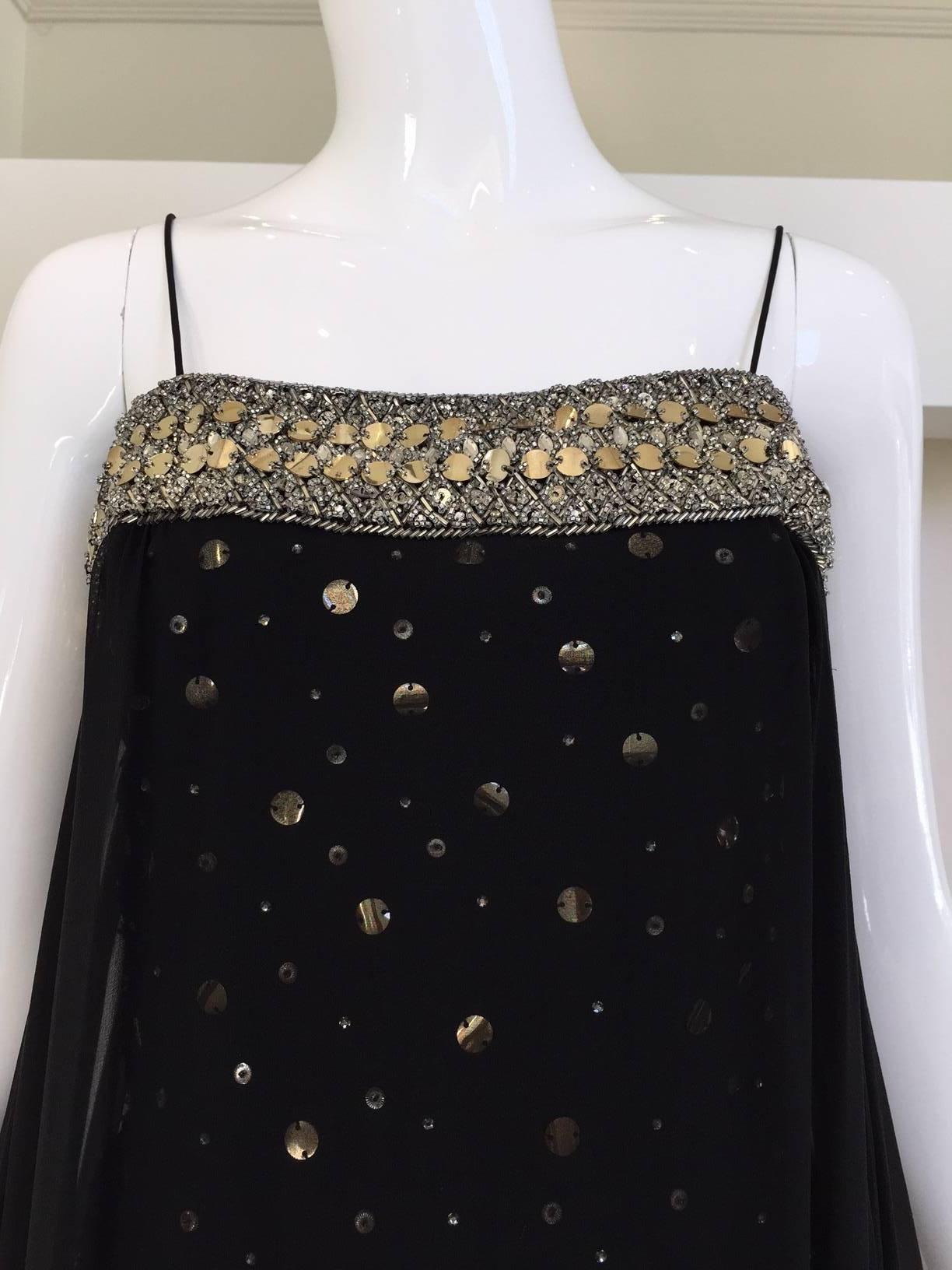 Vintage 1960s black spaghetti strap silk overlay cocktail gown with rhinestones. Lining is encrusted with Silver Sequins paillettes.  Unlabelled. This gown could be designed by Malcolm Starr or Sarmi, 
Size: 4/6  Small - Medium