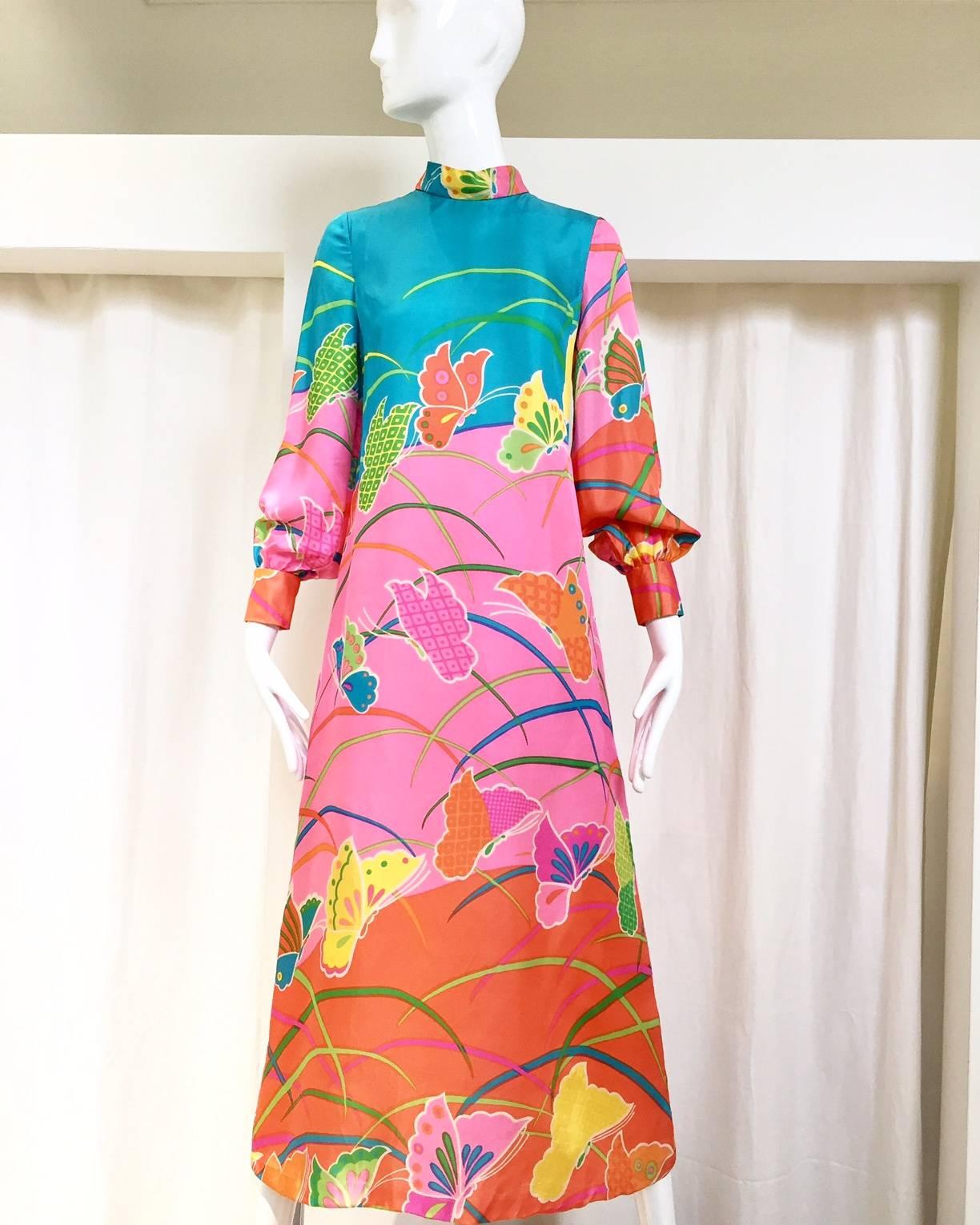 Vibrant 1970s Hanaemori butterfly print in orange, pink and teal maxi silk dress.   Size 6 . fit to medium.
 Bust: 34"/ Waist: 34"/ hip: 40/ Length: 49.5"
note: flaws at the back ( see image#4) small stains at the hem