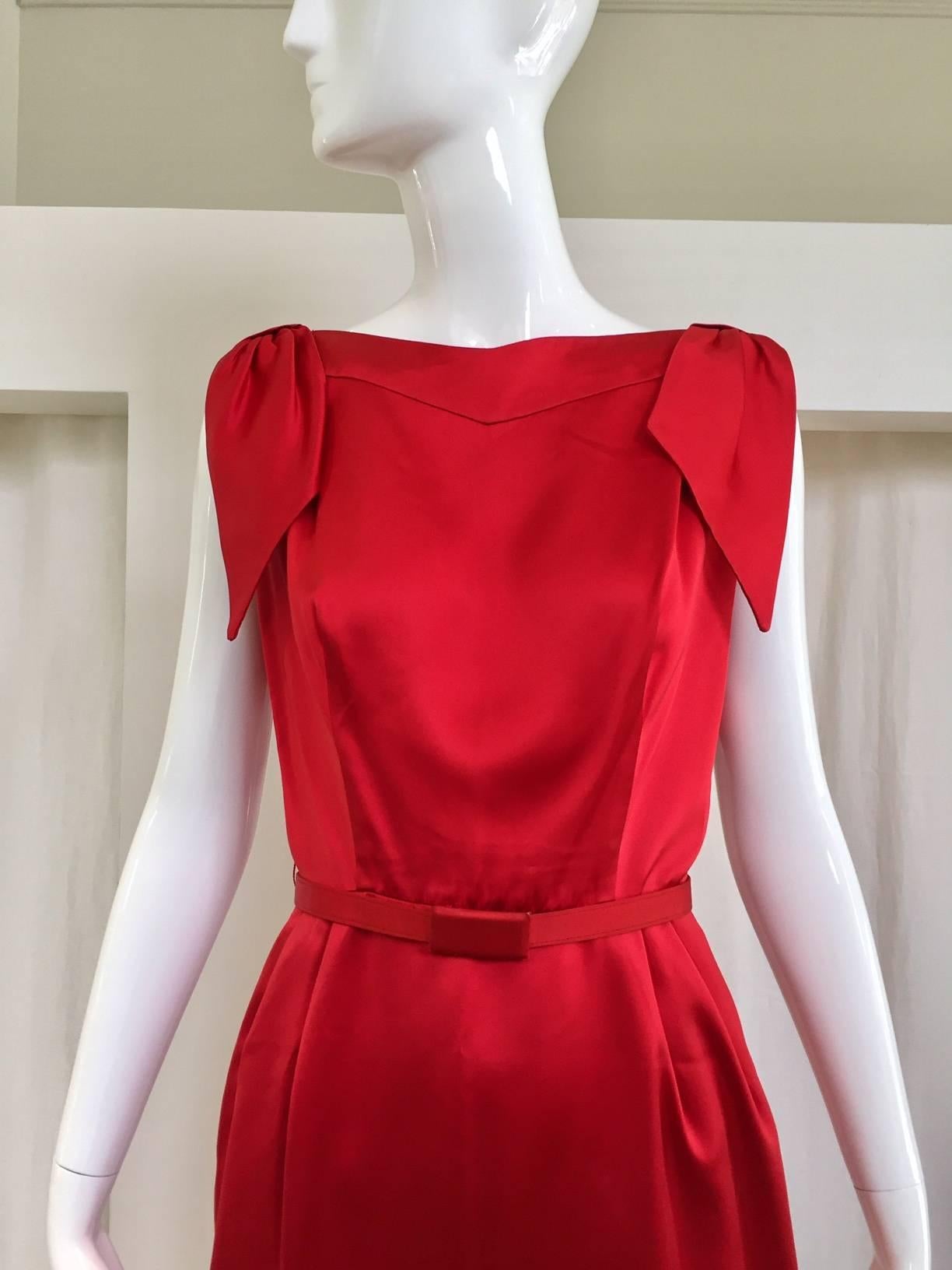 Sexy and timeless early 1960s sheath Cocktail dress by Don Loper.  Satin belt. Bows on shoulder. Classic Audrey Hepburn style. 
Bust: 36