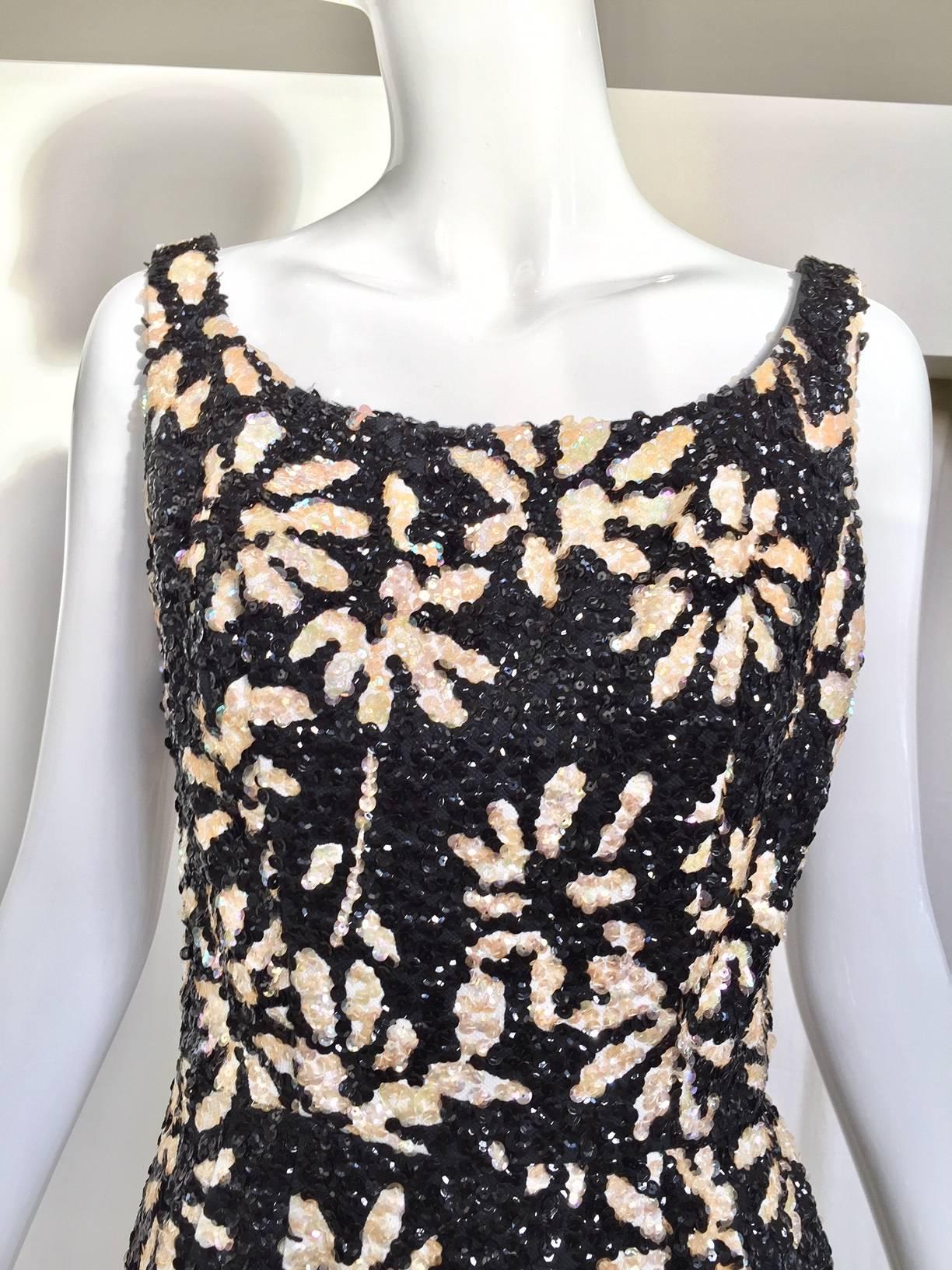 Late 60s Black and white floral pattern sequin wiggle dress.  The actual sequin color is almost pale pink. Perfect cocktail party dress
Bust: 36