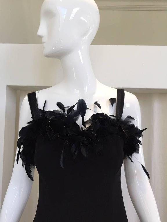 1970s Black crepe sheath dress made in france. Ostrich feather trim ,spaghetti strap.  Fit size US 2
Bust: 30