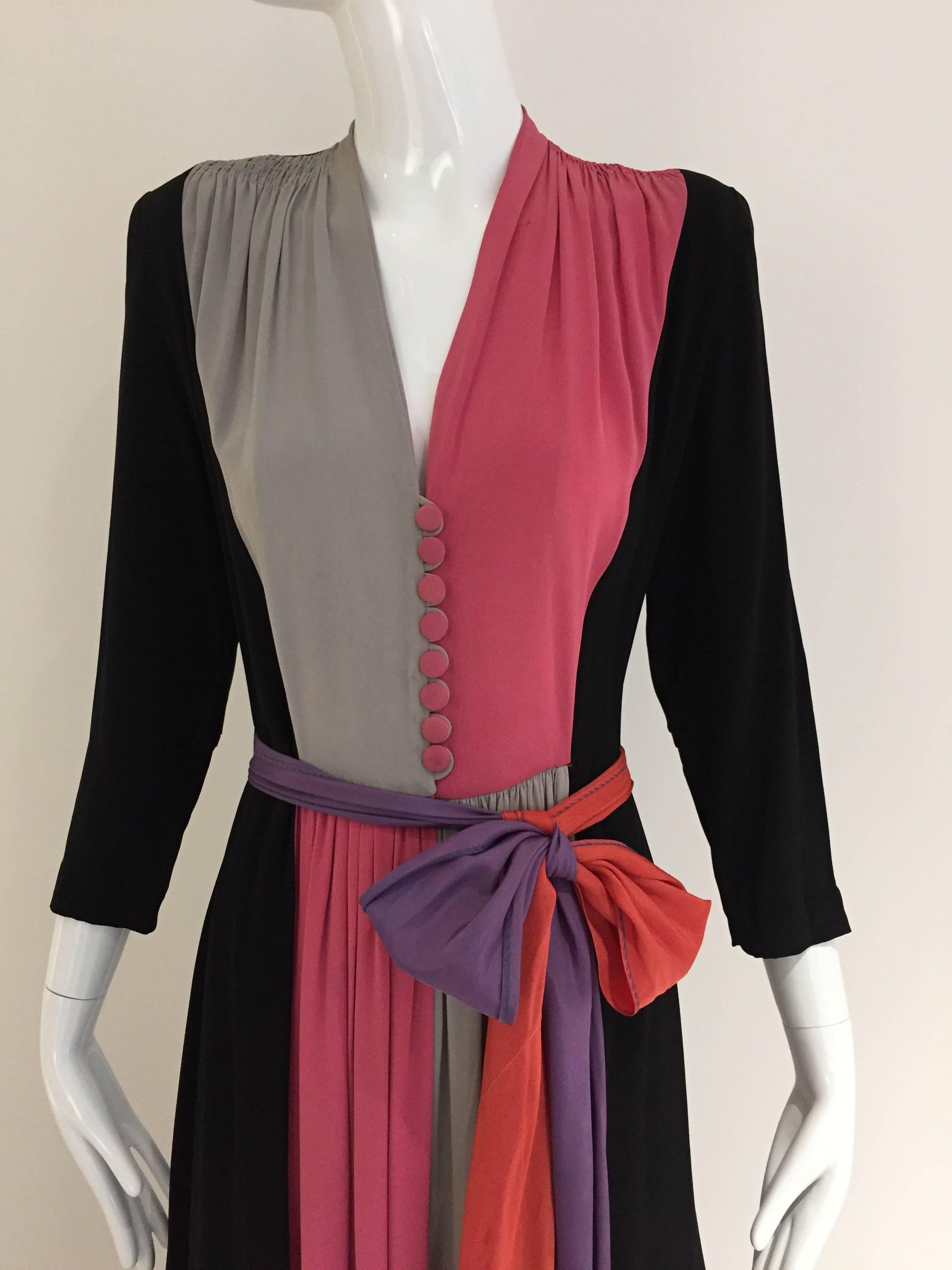 1940s silk dress in pink, black grey and purple silk dress. Soft padded shoulder and button in front. sash belt. some stains see image attached
Bust: 36 inches / Waist: 27 inches / Dress Length: 54 inches

***There are some minor stains on the