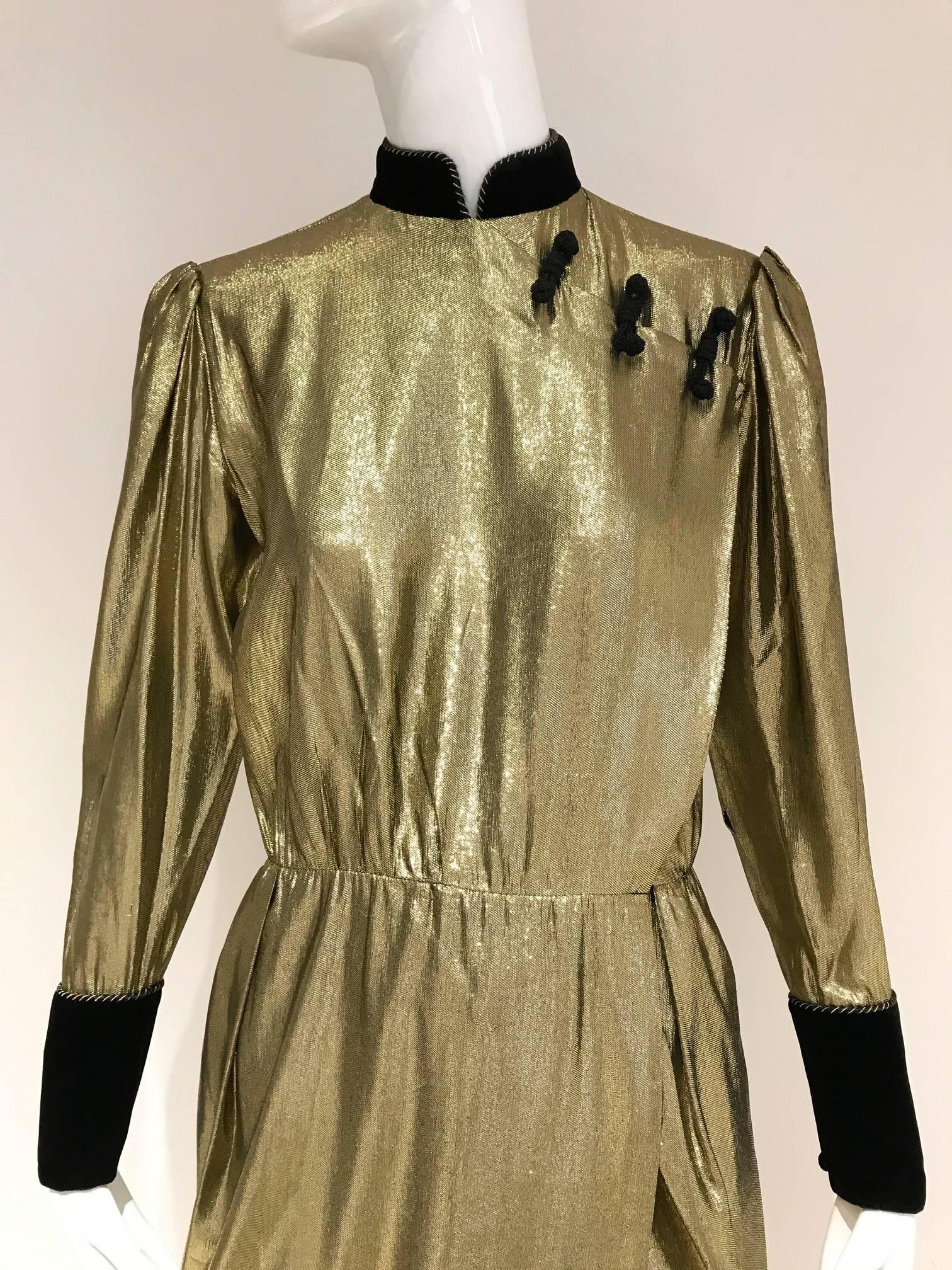 Chic 1980s Christian Dior gold lamé cheongsam inspired wrap  dress with black velvet cuff and frog fastener.  Fit size 2/4
Bust: 38 inches / Waist 26 inches/ Hip 38 inches/ Length: 56 inches.
Sleeve 23 inches