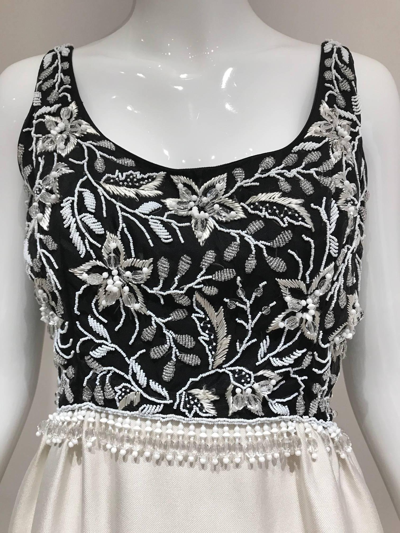 Vintage Malcolm Starr sleeveless black and white cocktail dress with beaded bodice.  
Fit size 4. 

**** This Garment has been professionally Dry Cleaned and Ready to wear.

