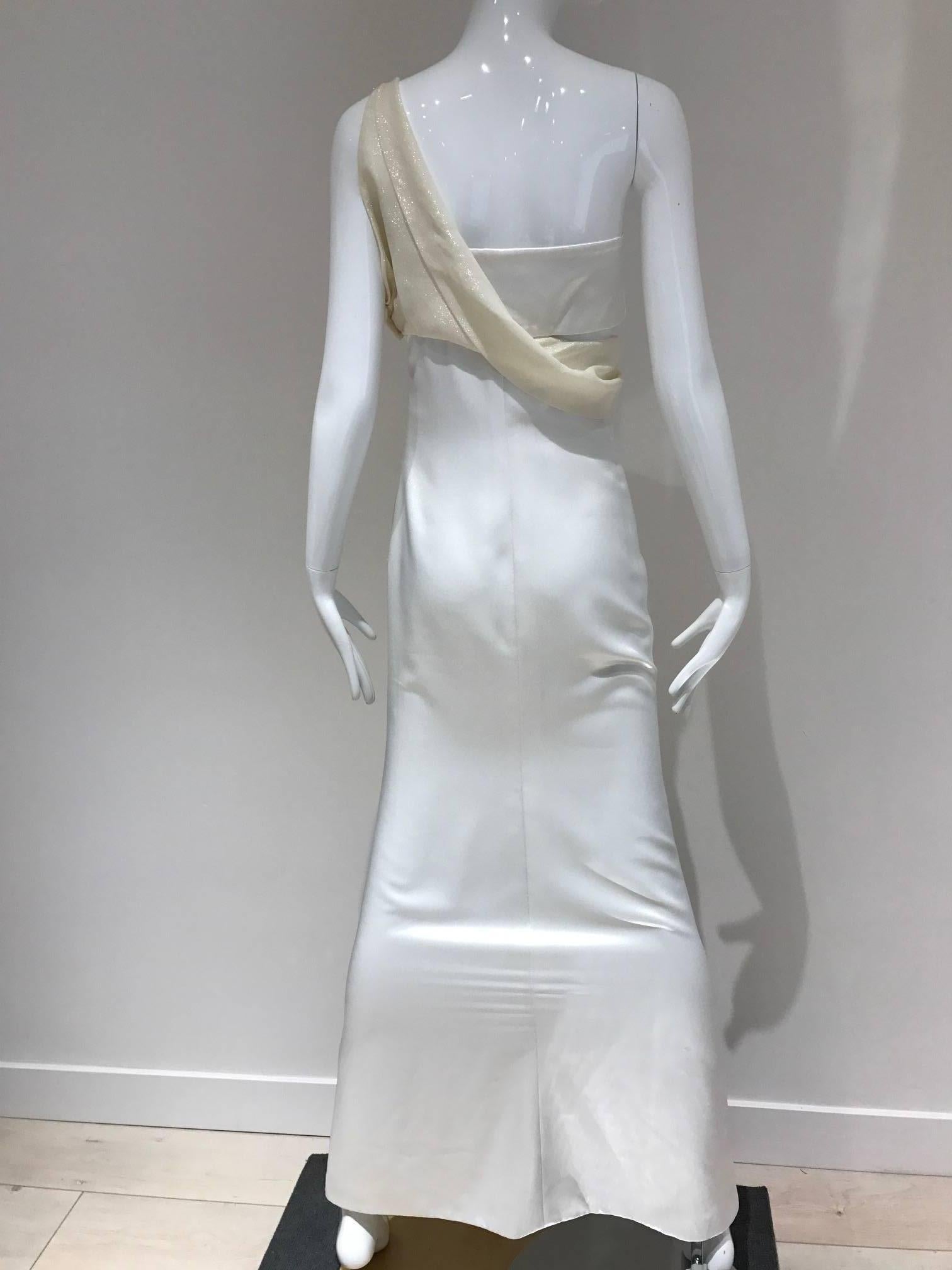 Graceful and sleek Gianni Versace white silk gown.  A very chic take on the Sari, combining wite satin and shimmering silver lamé.   What appeals to me about this gown is the way Gianni eliminated all useless ornament, leaving only the core of what