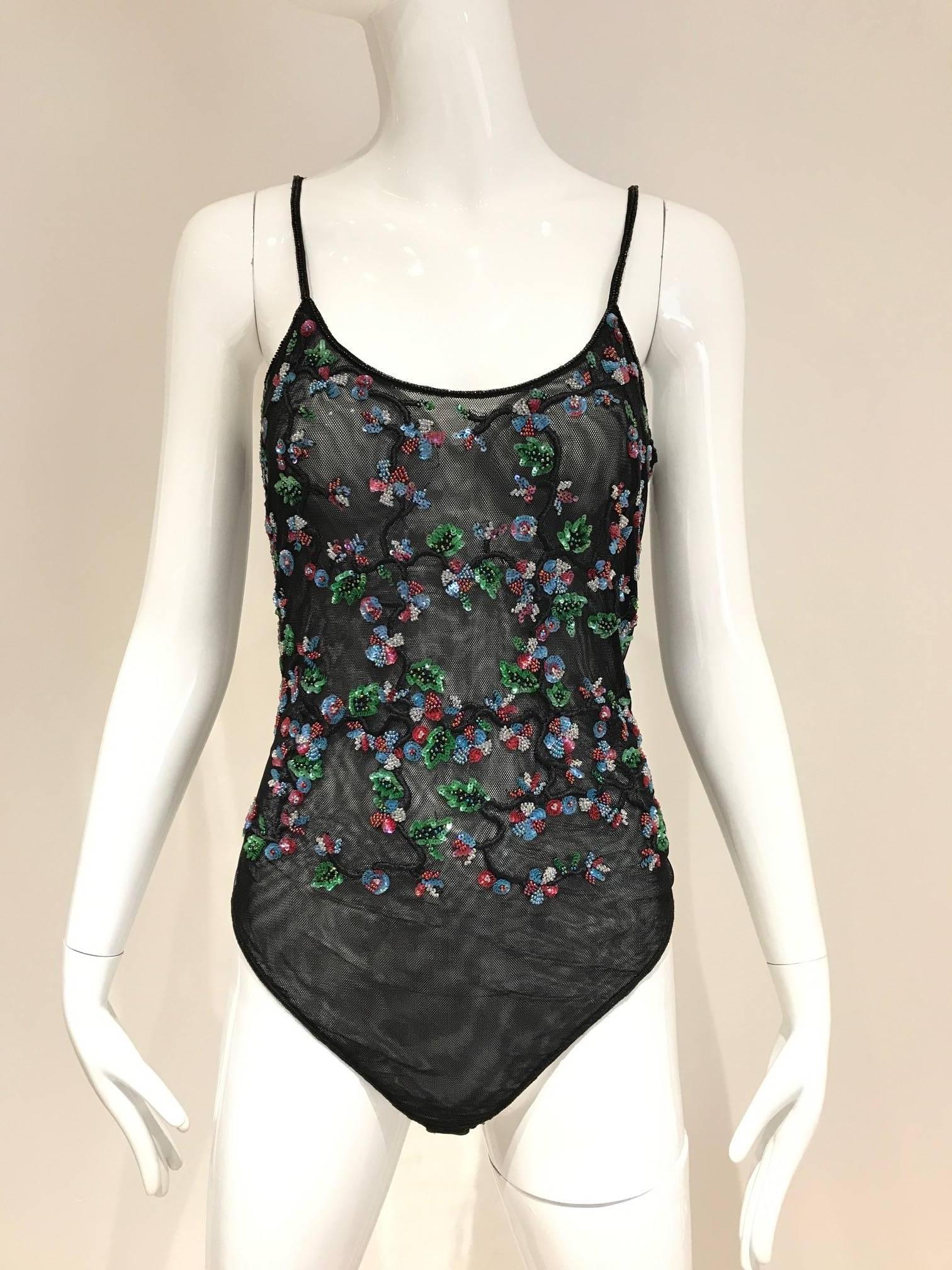 90s Giorgio Armani ( label has been removed) see my other Armani body suit.
what a beautiful workmanship! beaded with multi color sequins mesh body suit or one piece swim suit perfect with skirt or evening pants. 
Fit size 4/6