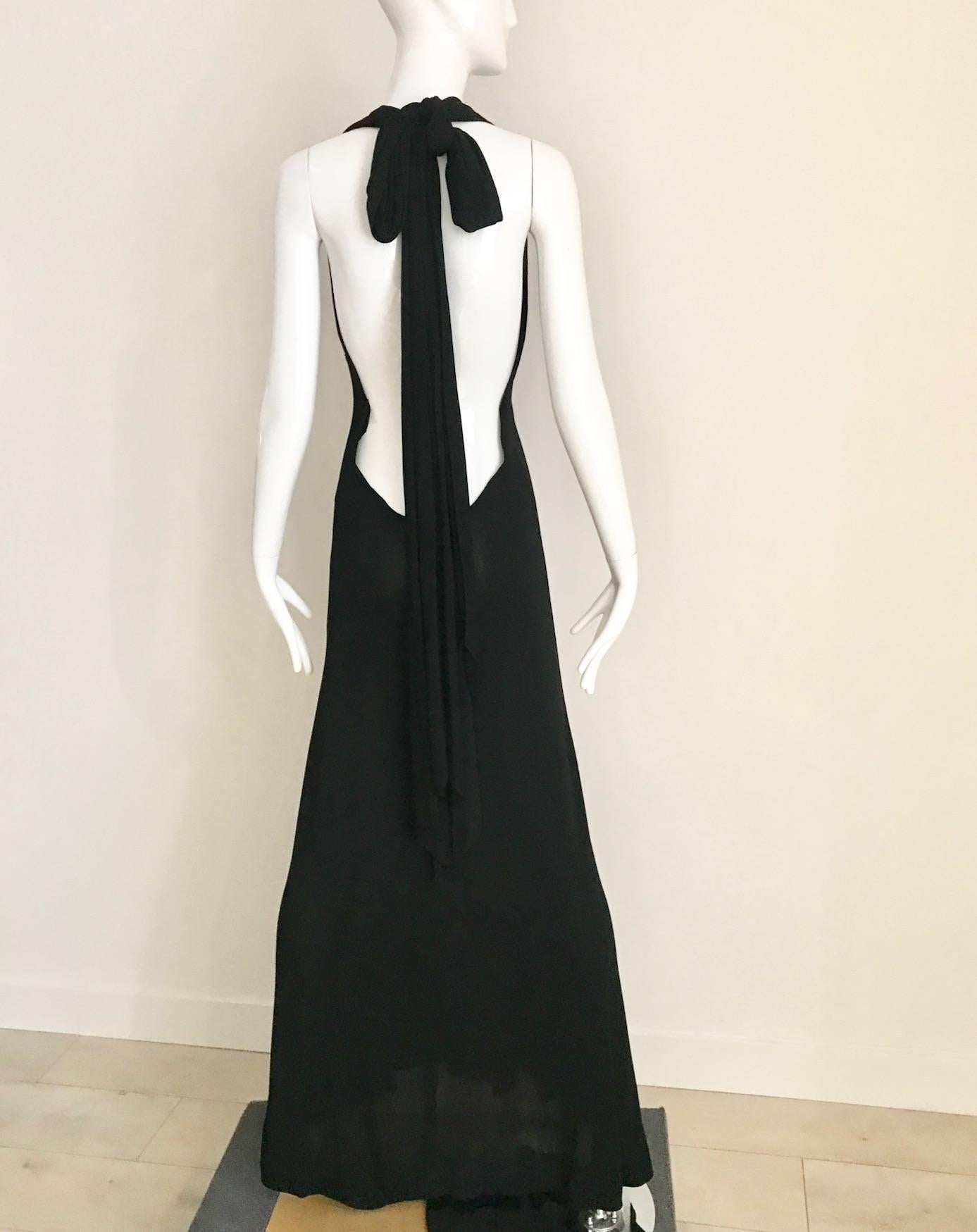 Sensational 1970s Halston black matte jersey gown with bare back. Long jersey train can be tied as a bow or let it hang.  Bare is exposed. Slip on gown with no zipper or fastener. Halston is a master of the bias cut! 
SMALL-Medium
Bust: 34" 