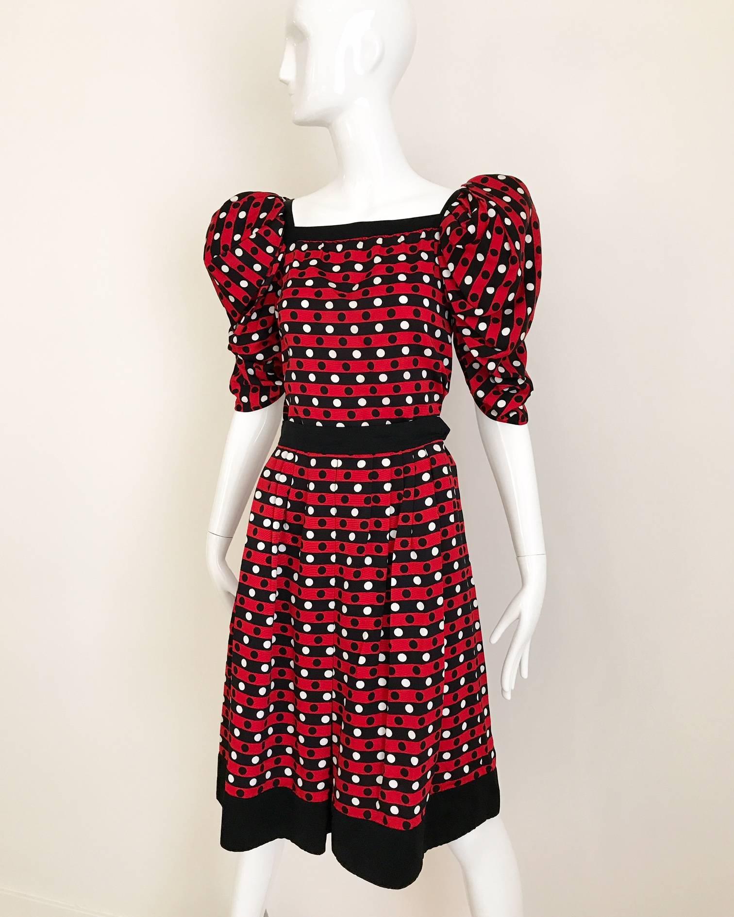 Early 80s Yves Saint Laurent red, white and black polkadot silk twill blouse with puffy sleeves. slip on blouse ( no zipper) knife pleats skirt with pockets.
Blouse fit size 2/4/6 Small- medium 34" bust / hip : 38 ( blouse)
Skirt: 24" (