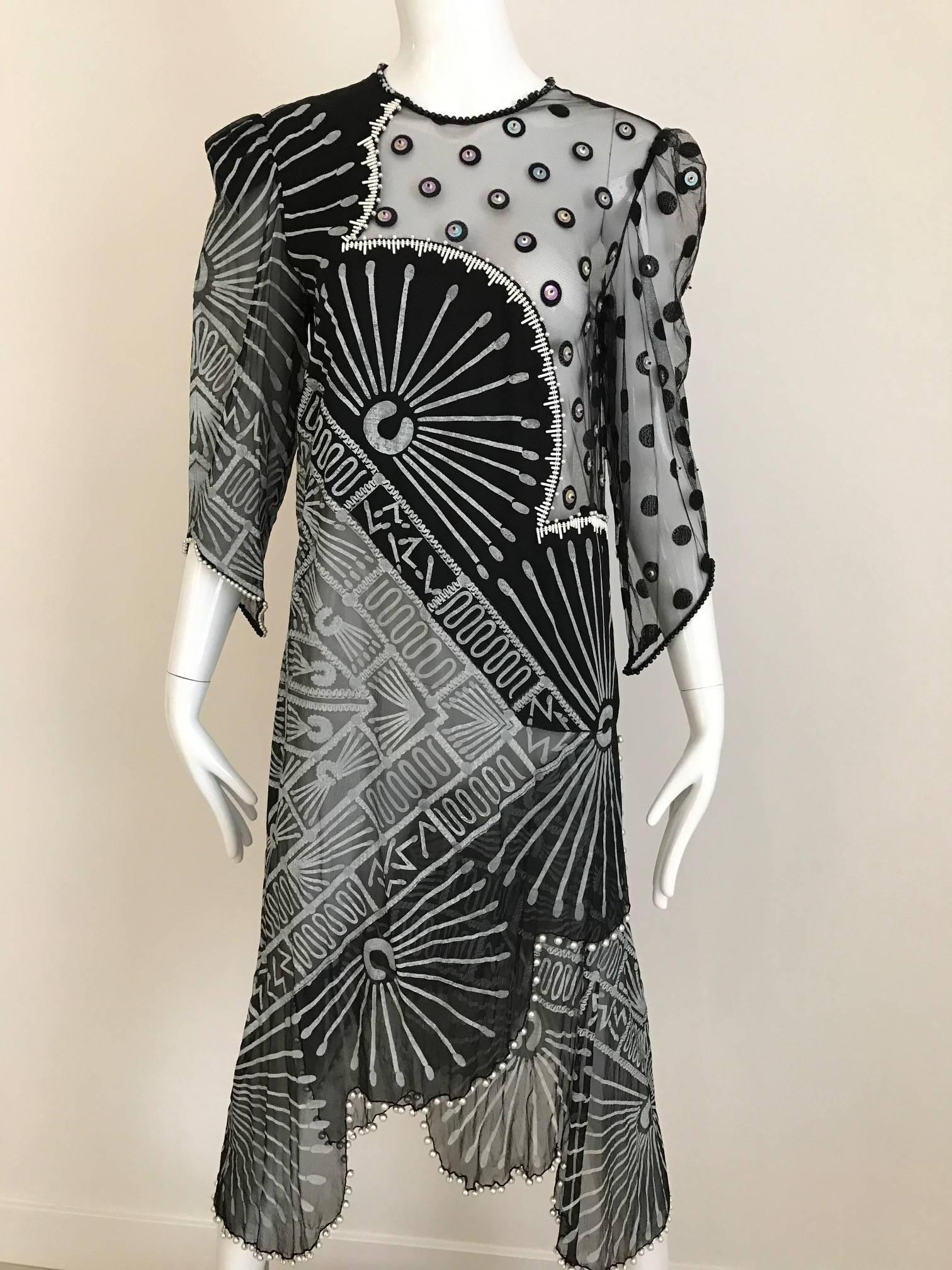 Vintage Zandra Rhodes black and grey hand painted print silk chiffon dress with sheer bodice. (for modest coverage see picture #1) #1 dress shown with black one shoulder Jersey slip (dress comes with the slip) 
Bodice part has black velvet circle