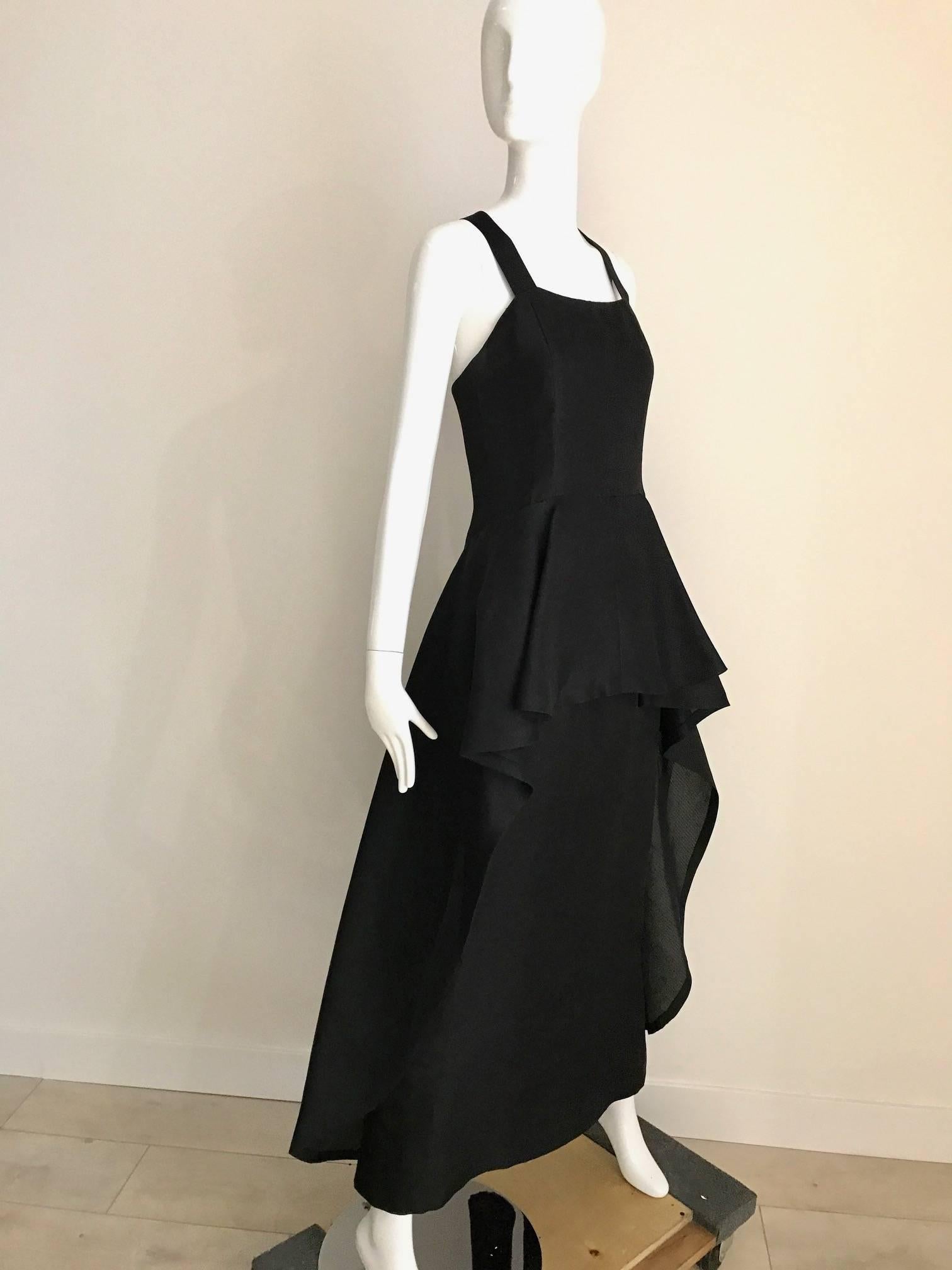 Timeless and chic Vintage Givenchy black silk organza gown with cris cross back and slightly cascading peplum hem. This vintage Givenchy gown is a signature look epitomized Audrey Hepburn classically chic style.
Bust: 32 inch
Waist: 27 inch
Hip: 39