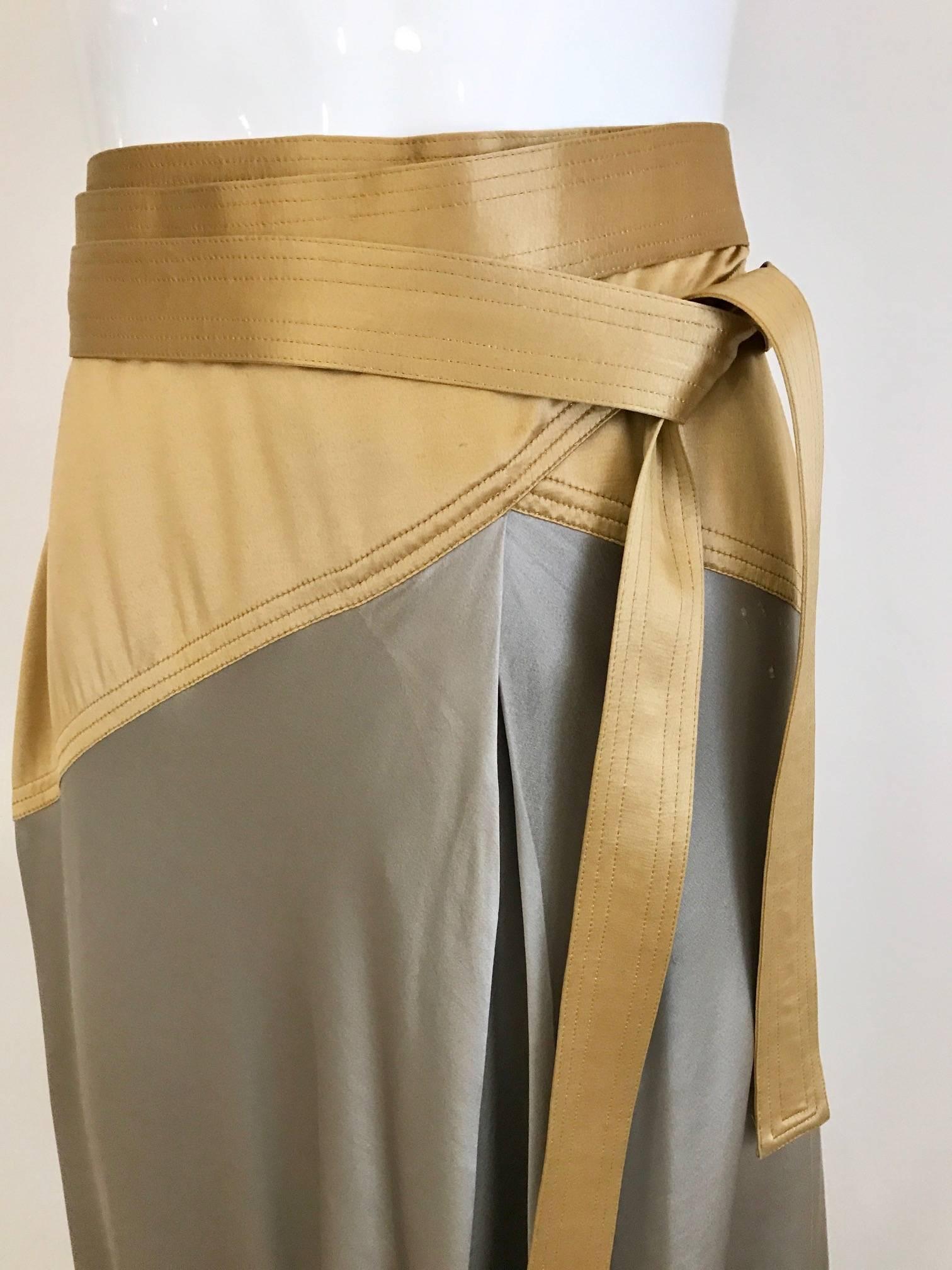 This vintage 90s Geoffrey Beene gold and gray silk charmeuse wrap skirt is very slinky but elegant! The gold sits on the hips and extends around the body in the long wrap belt, with the shiny silver silk adorning the bottom of the garment. We styled