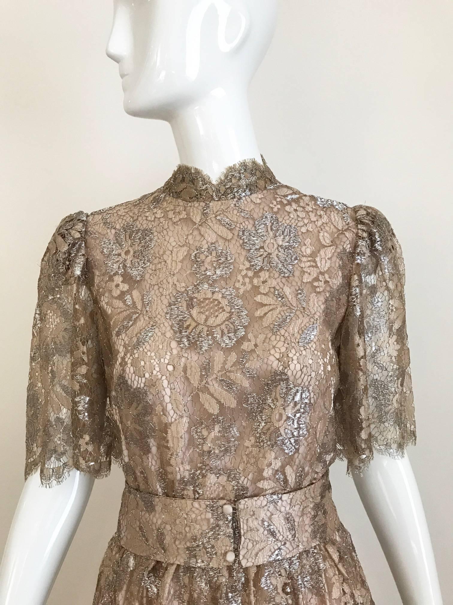 Vintage light gold metallic lace 3 tiered cocktail dress.  Dress comes with belt. 
Dress is in excellent condition.
Size Small
BUST: 34 INCHES
WAIST: 26 INCHES/  DRESS LENGTH: 48 INCHES