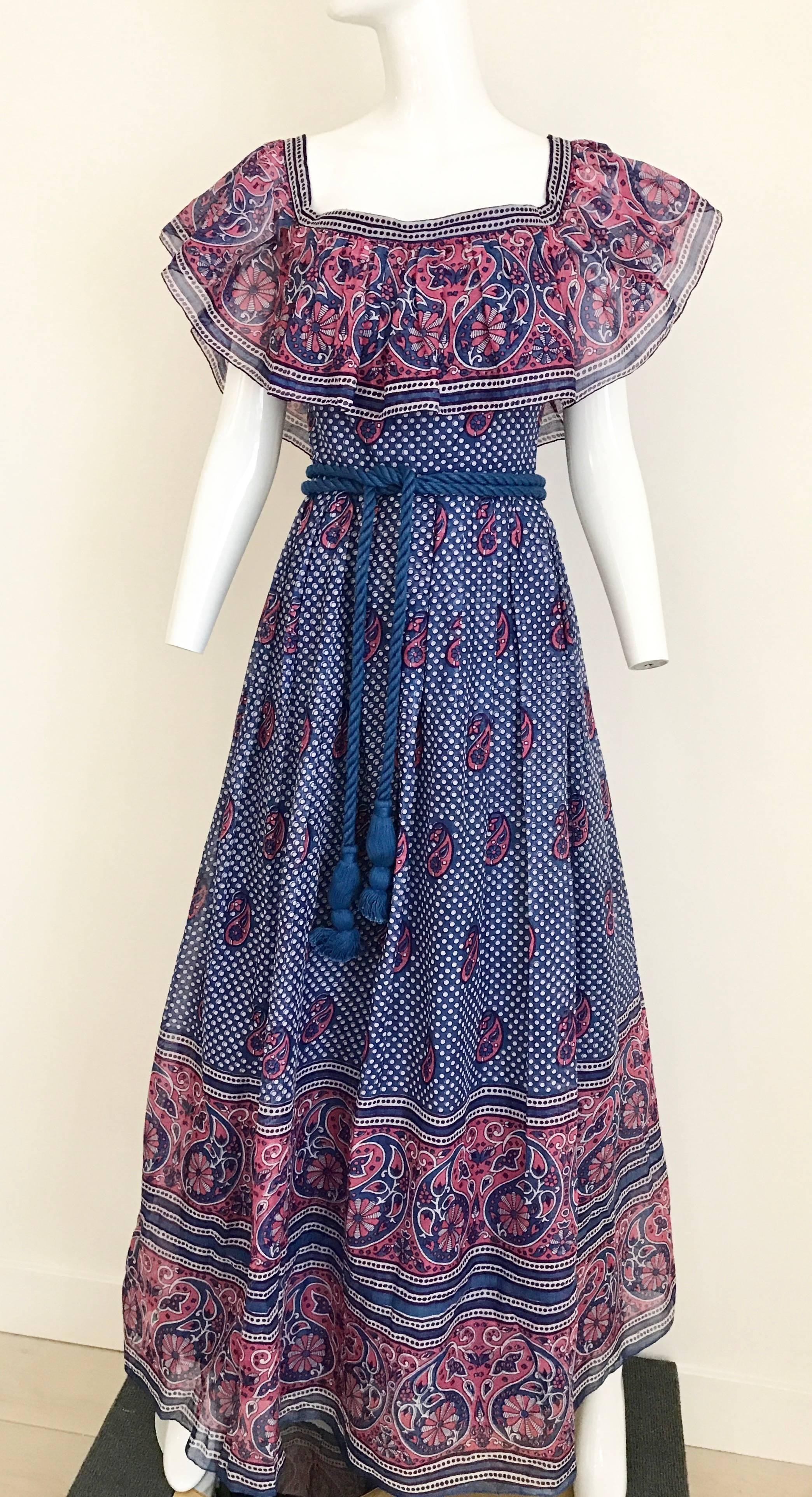 Vintage 1970s cotton, off shoulder blue and pink paisley Indian print maxi dress is a perfect summer vacation dress. Dress comes with a thick blue rope belt. The dress can be worn off shoulder (peasant style) or on the shoulder.
Measurement: 
Bust: