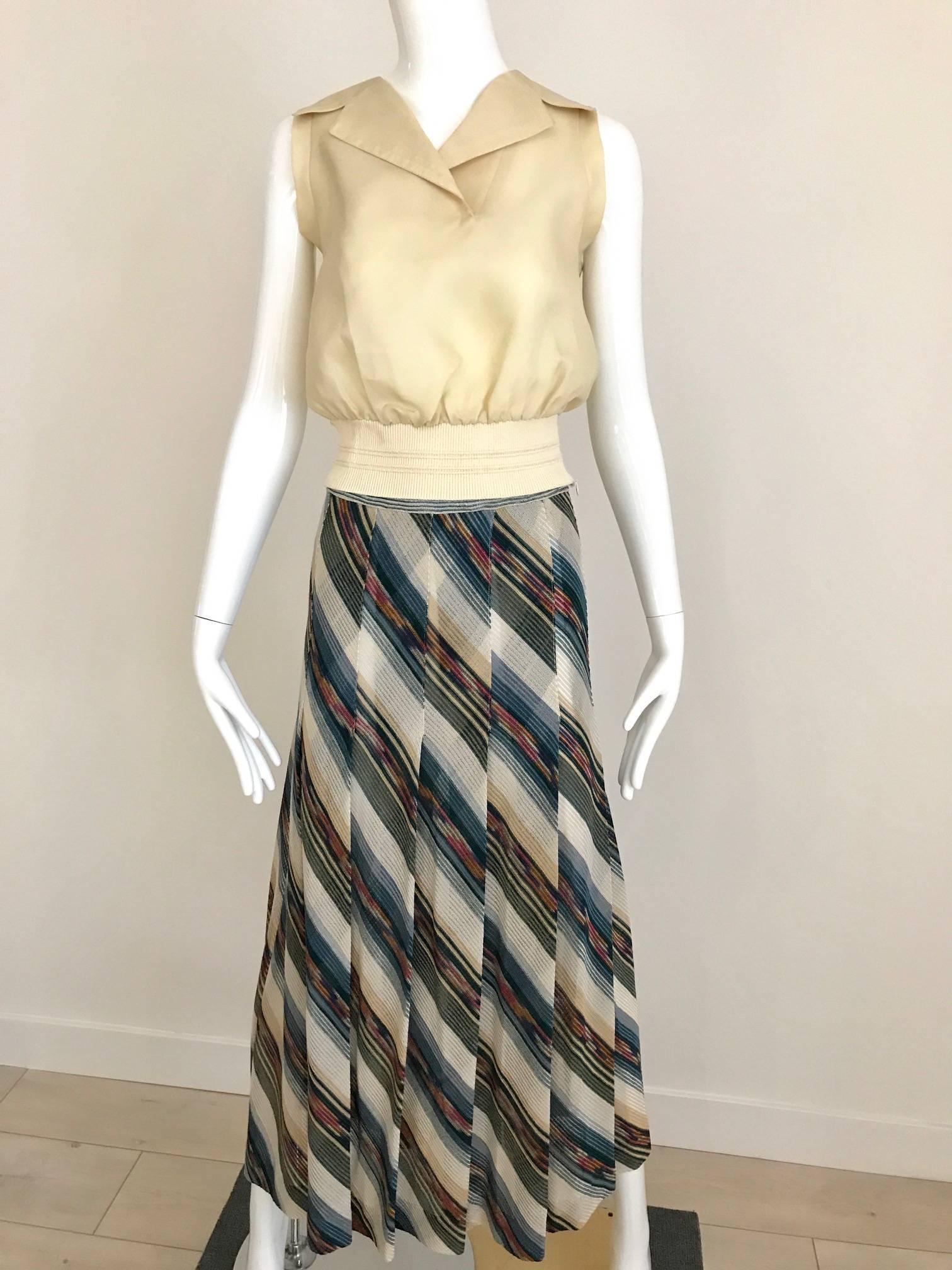 This vintage 1970s Missoni diagonal stripe knit maxi skirt has a subtle rainbow of colors. Beige, blue, teal, gold, orange, raspberry in a soft beautiful knit, results in a very sophisticated look. Perfect for vacation wear that will not wrinkle and