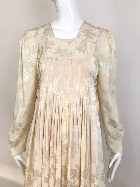 This vintage 1970s Bohemian Ossie Clark ivory rayon jacquard maxi dress is exceptional. The rayon jacquard fabric is super soft and quite heavy. Although many Ossie Clark dresses would be considered to be hippie, this beautiful ivory creation is