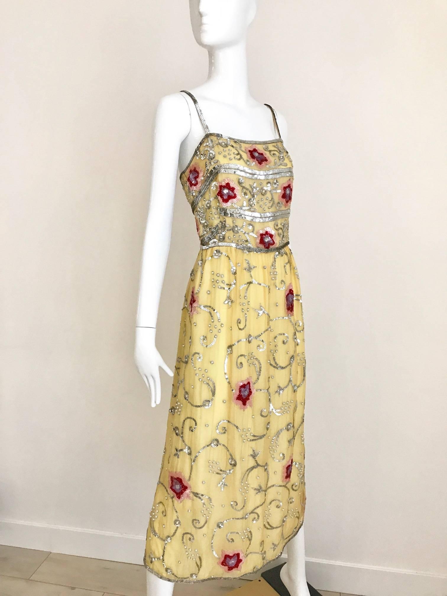 Vintage 1960s profils du monde Yellow silk chiffon gown adorned with red , silver sequins and pearls. Timeless and chic old hollywood glamour style. Fit modern size 6 /8 
Measurement: 
Bust: 38 inch / Waist: 28 inch / Hip: 40 inch  
Dress length: 50