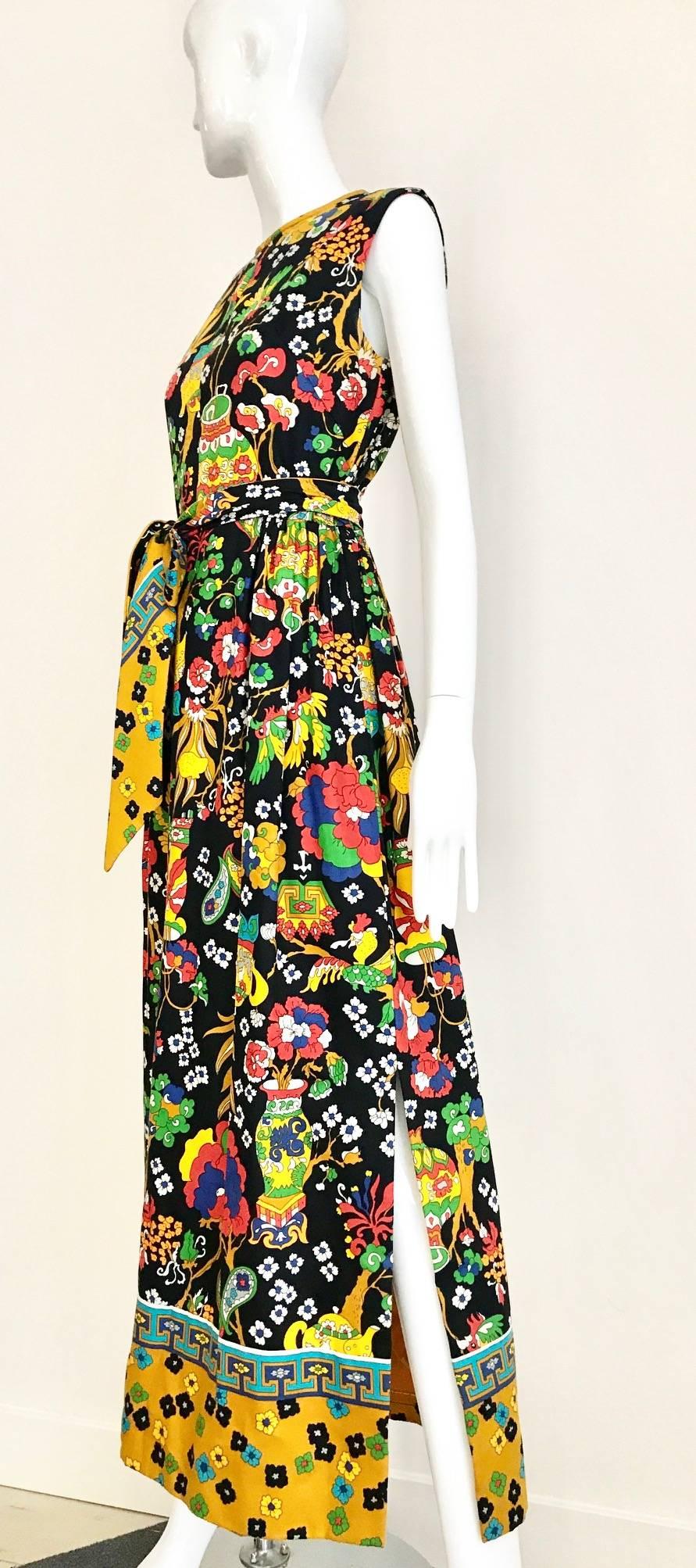 Vintage Late 1960s and early 1970s Multi Color Bold novelty Print Sleeveless Cotton Maxi Summer Dress. Featuring Bold Print of birds, flowers and trees in yellow, green, black, red, and blue. Dress comes with reversible two different color of prints