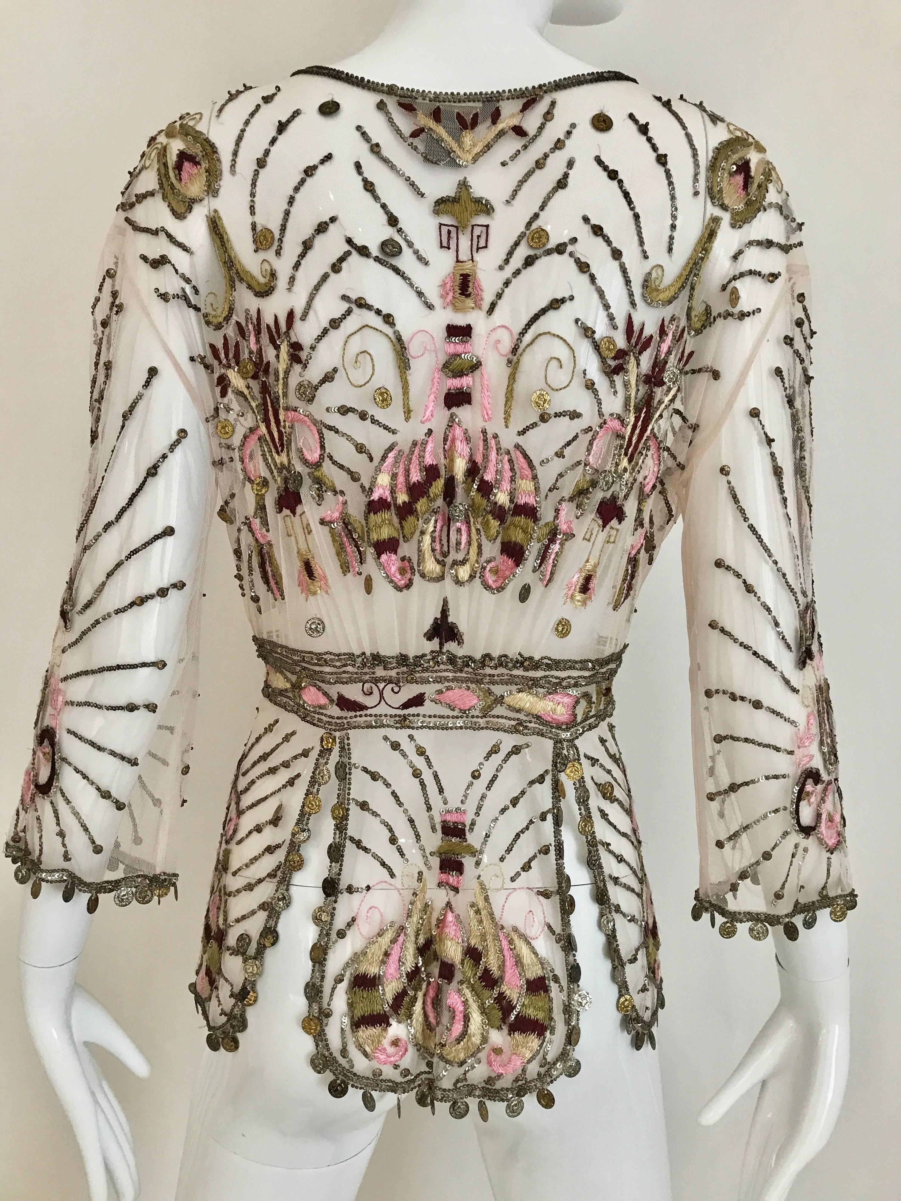  Vintage Roberto Cavalli Pale pink sheer embroidered mesh beaded silk cardigan jacket.Cardigan is embroidered in gold, pink, and burgundy silk thread troughout.   Three quarter length sleeves. cardigan/blouse has tie closure. gold charms on the