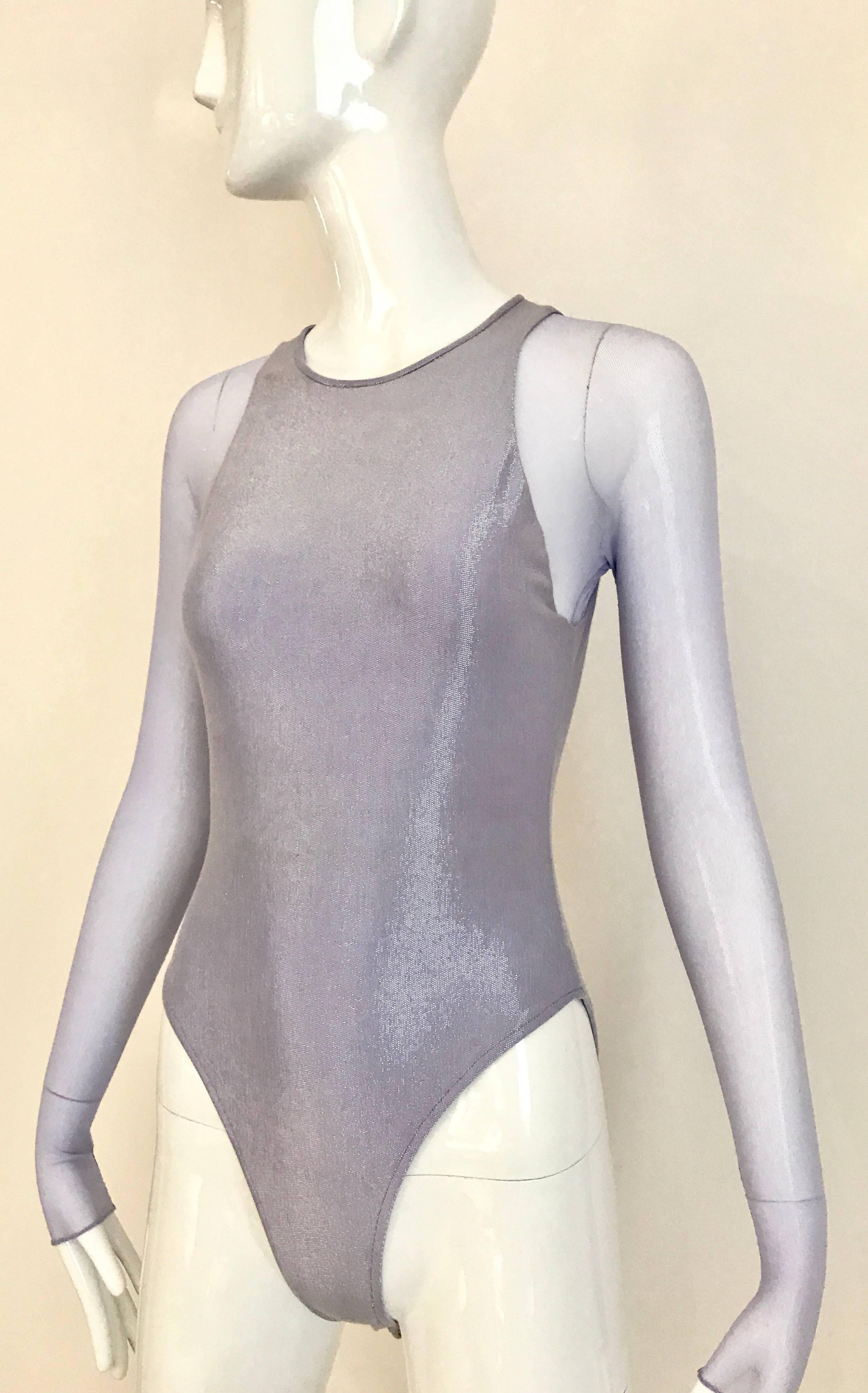 Vintage 1990s Giorgio Di Sant Angelo Lilac Metallic Long Sleeve Body Suit. or bathing suit . Sheer Sleeves and shimmer lilac bodice. Snap on body suit. Excellent Condition.
Fit best US size 0/2/4 max.
Bust: 30 inch  stretch up to 34 Inch
Waist: 24