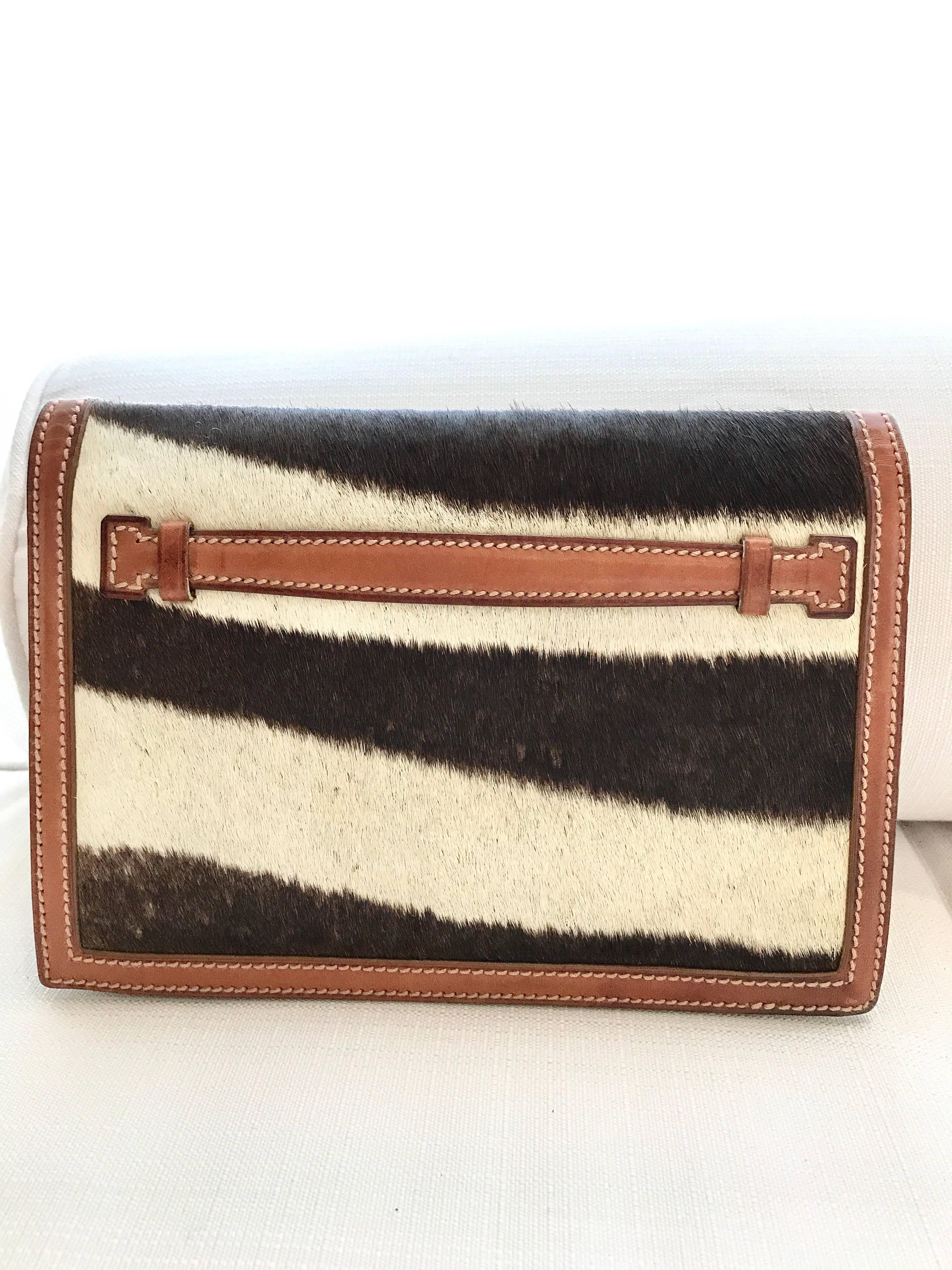 Timeless and chic vintage Ralph Lauren pony hair leather clutch. 
Fit Iphone 7 plus, lipstick, key and small credit card wallet. 
Measurement:
Width: 9 inch   /Height: 6 inch  /  Depth:  2 inch
