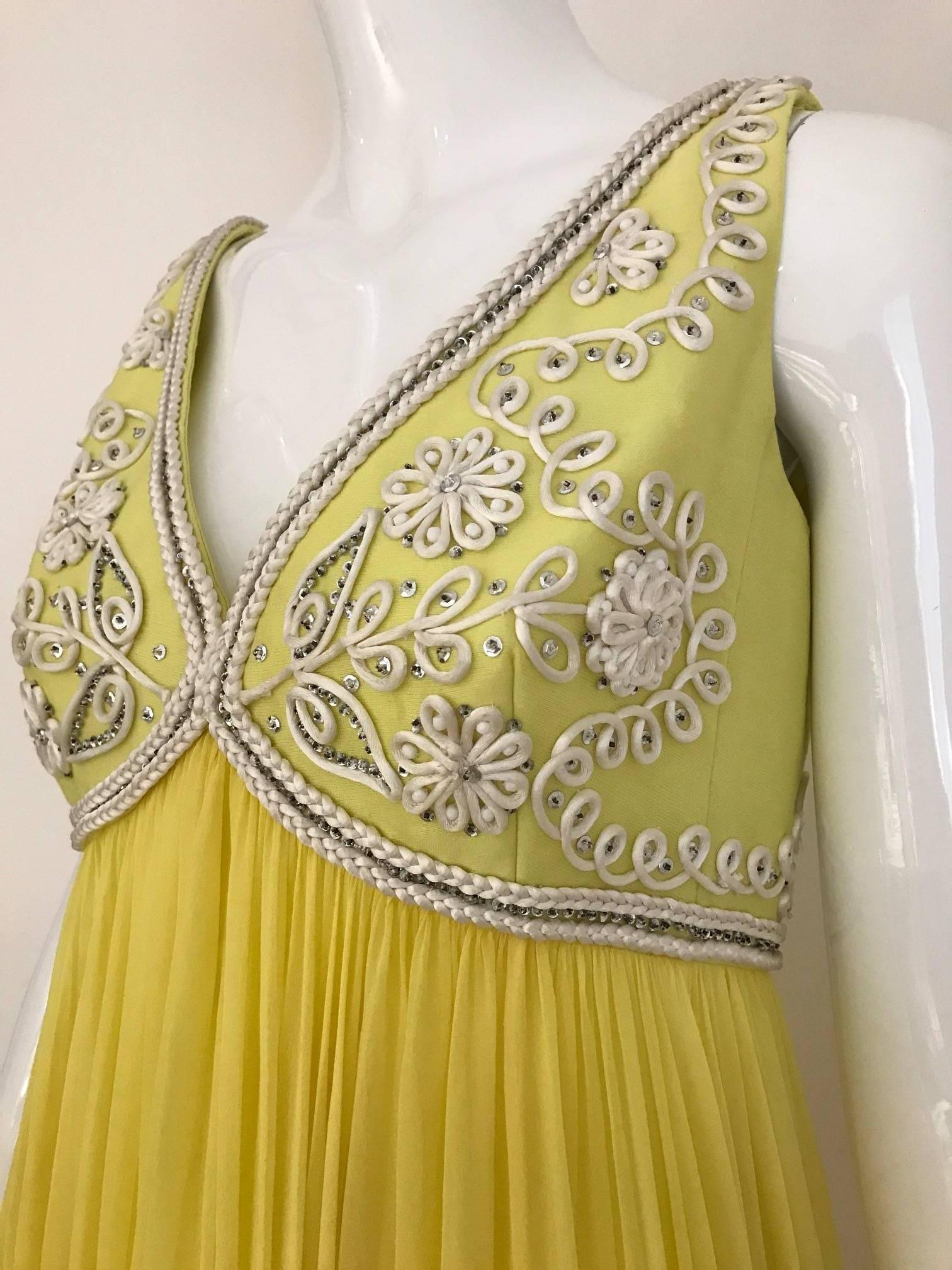 Bata vintage Sylvia Nechis de los años 60, de gasa de seda amarilla, sin mangas y cuello en V, con conjunto de chaqueta recortada. Soutache de cordón blanco y lentejuelas plateadas por todo el corpiño y la chaqueta. Vestido de novia o de dama de