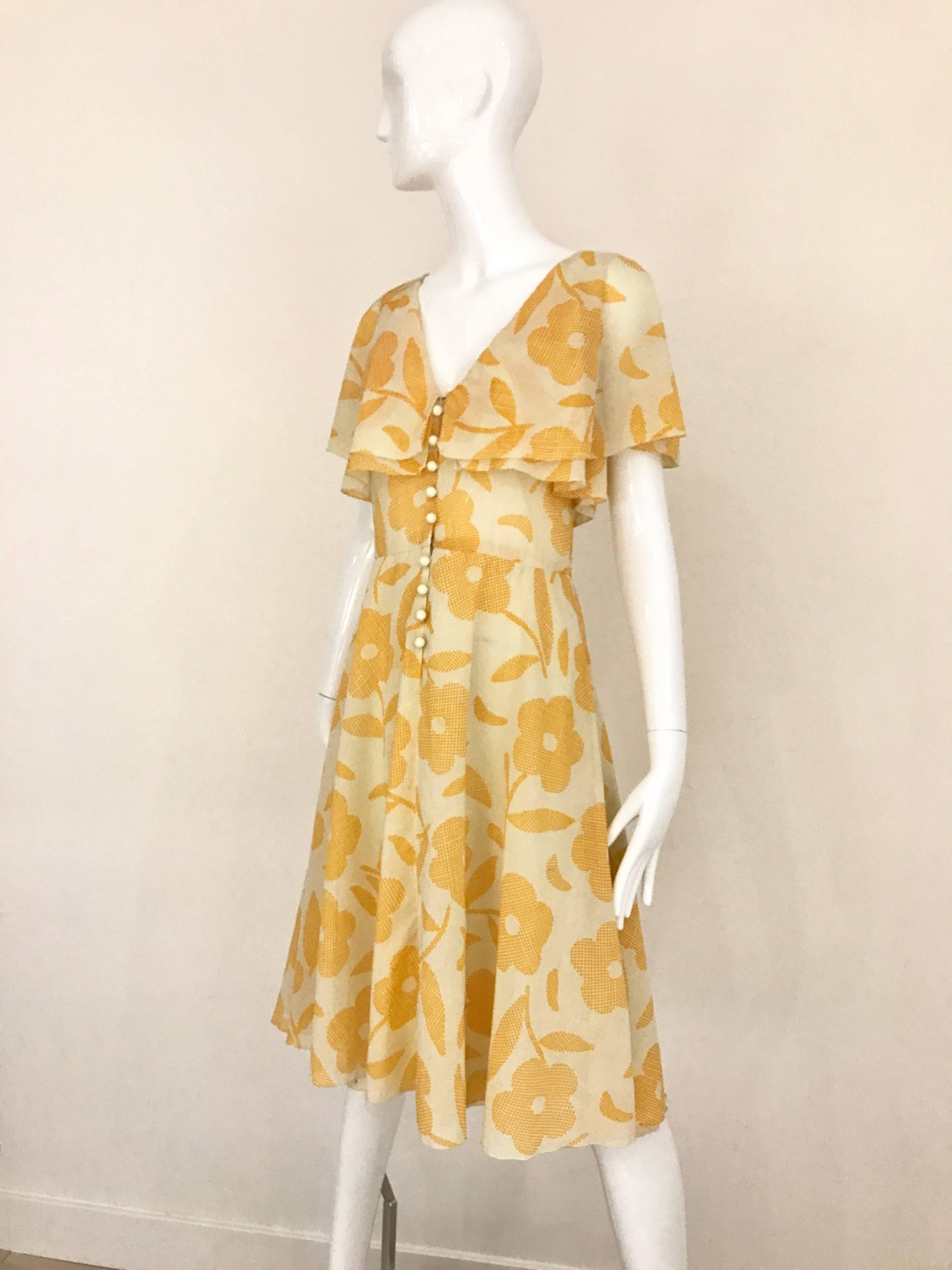 1990s CHLOE  V neck Yellow and Cremel Flower Print Cotton Vintage  day Dress. Creme acrylic button in the front, and double layer flutter sleeve.
Size:  4 / Small
Bust: 32 inch  / Waist: 27 inch/ Length: 41 inch

** lining has small tear not see