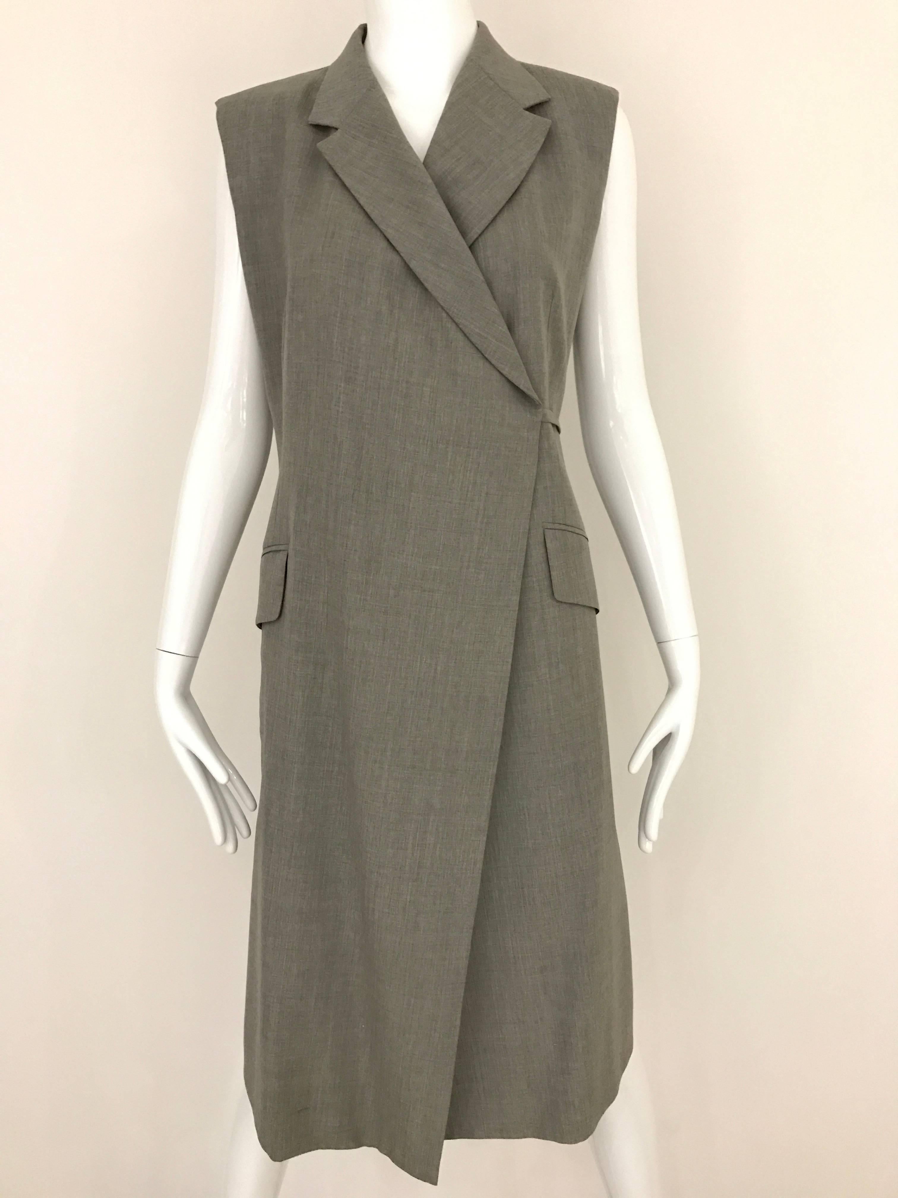 1990s  ISAAC MIZRAHI Gray Light Waistcoat Vintage Wrap Dress. Fabric made of light wool. Large Pockets on side and soft shoulder pad. Dress is lined in Silk. 
Simply Chic and modern. 
Size: MEDIUM 6
Bust: 36 - 40 inch  / Waist 30 - 34 inch  / Hip: