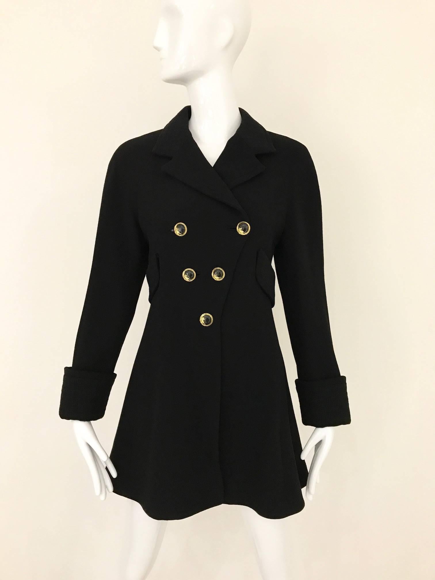 1990s Vintage Gianni Versace Couture label black crepe peacoat jacket lined in plaid silk. Slightly A line 2 side pockets, coat or jacket finish with gold and black enamel gianni versace button. Very flattering coat/ jacket.
Fit size :4