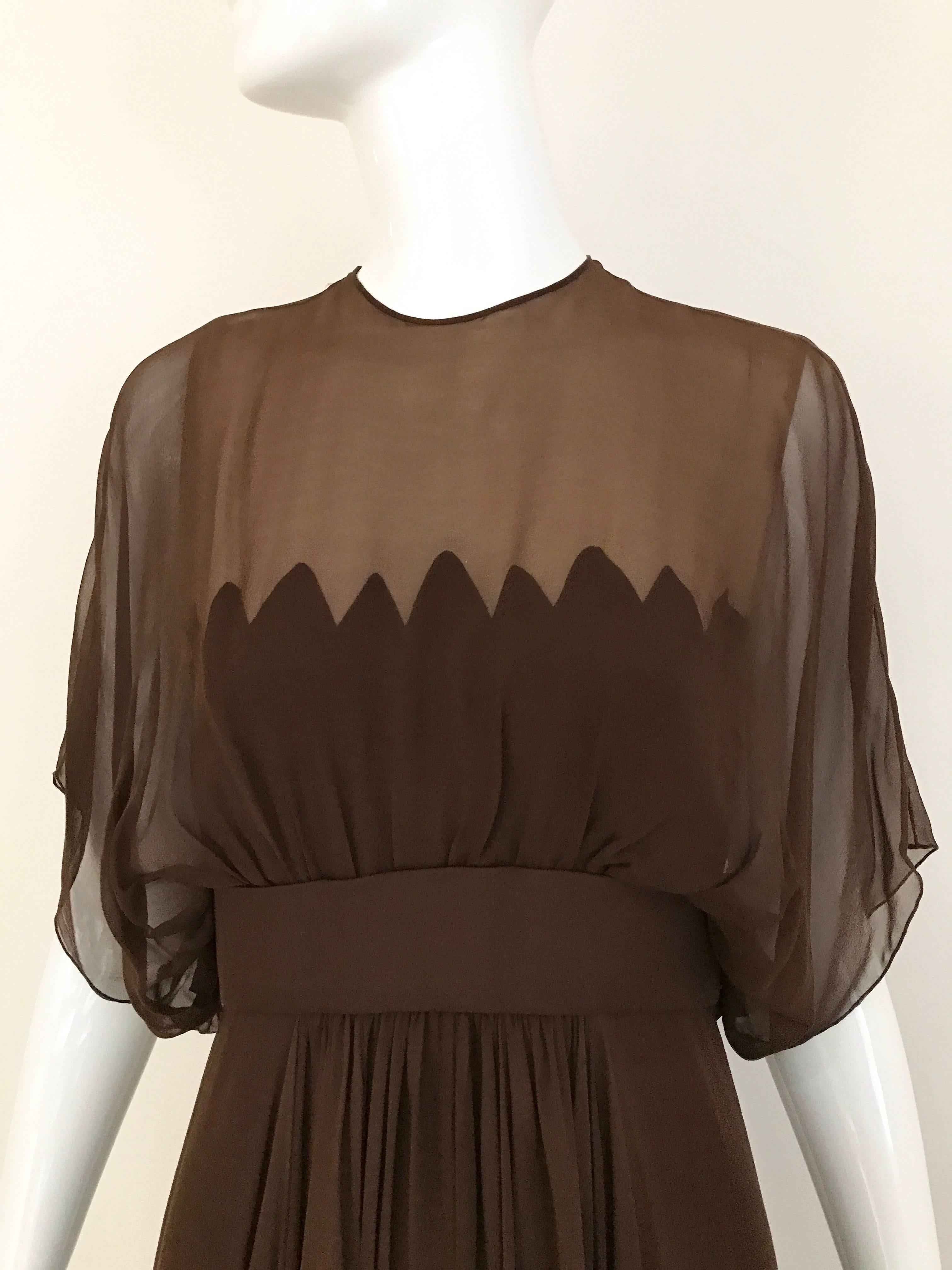 Beautiful Vintage Alfred Bosand 1950s cocktail dress with sheer bodice. Fitted on the waist with flowy skirt.  
Fit US 2/4 XSMALL AND SMALL
Bust: 34 inch/  Waist: 26 inch

** slightly small discoloration at the hem see image. 
*** discoloration in