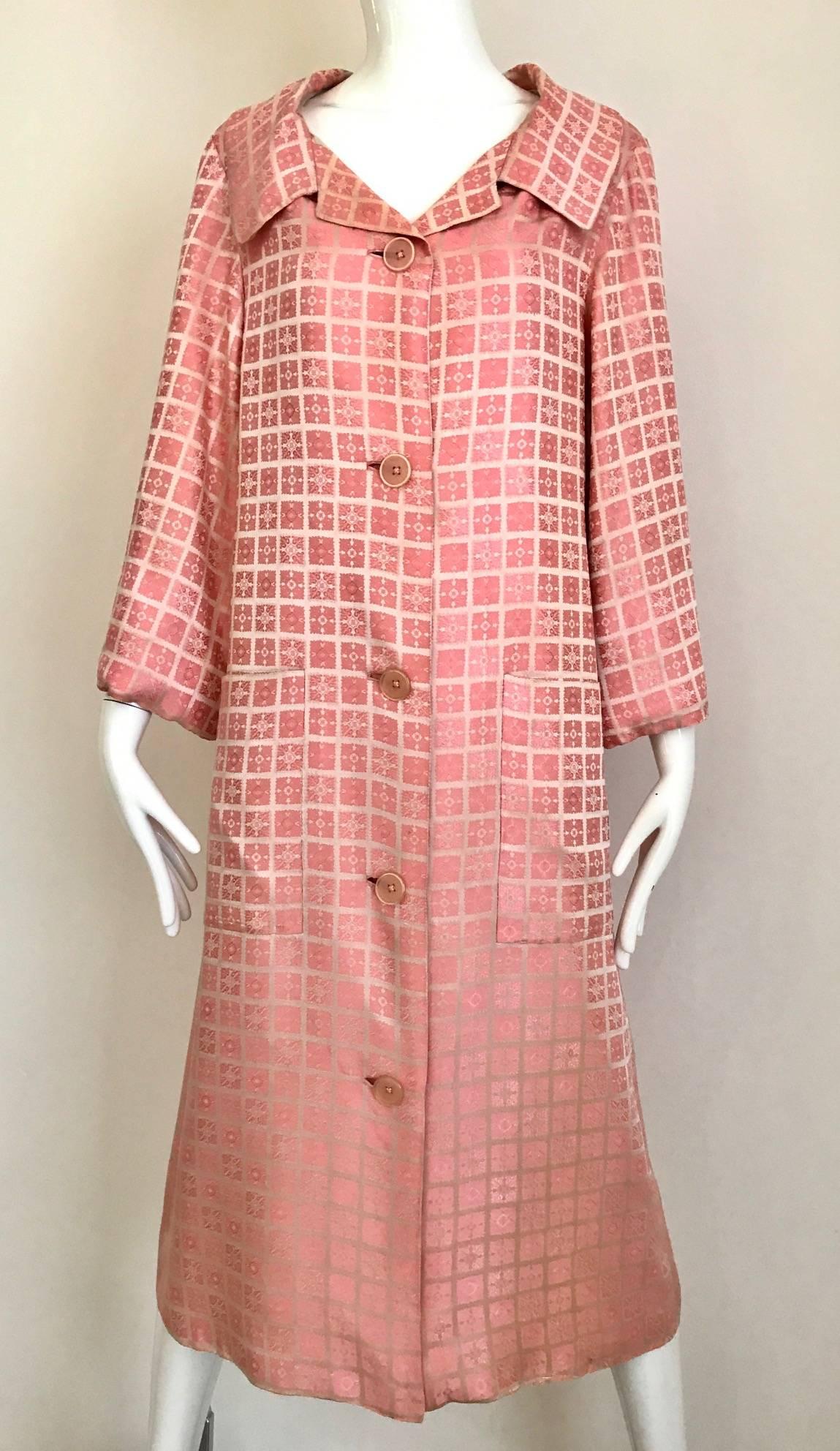 Vintage 1970s  Christian Dior Light Pink mosaic checkered print silk jacquard coat. 2 oversized pockets and silk belt. Coat lined in silk.
Size: Medium - Large
Bust: 40