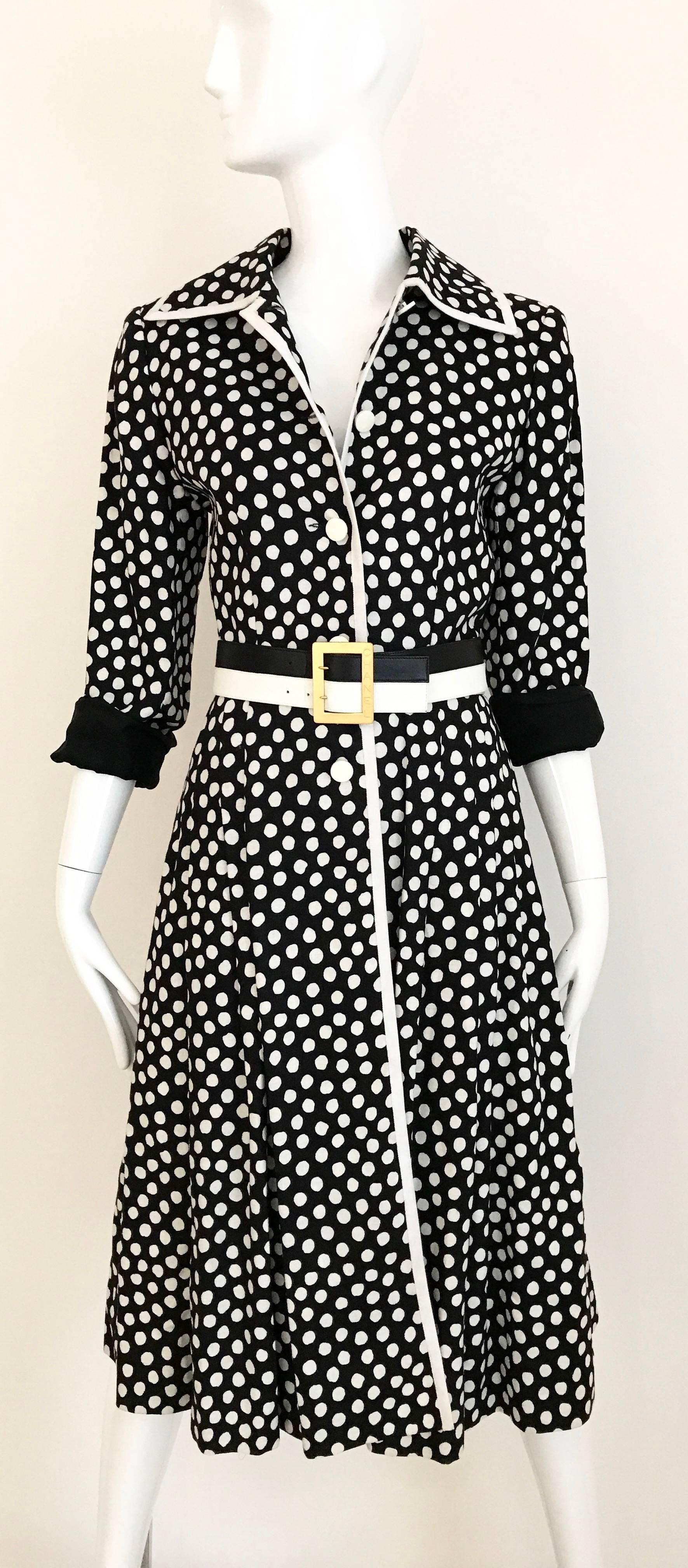 Vintage 1970s GIVENCHY Nouvelle Boutique black and White dot coat dress. 5 acrylic Button in the front and pleated skirt. Coat is made on linen and lined in silk.
You can wear this as a dress. Coat has 2 side pockets. Coat is styled with Vintage