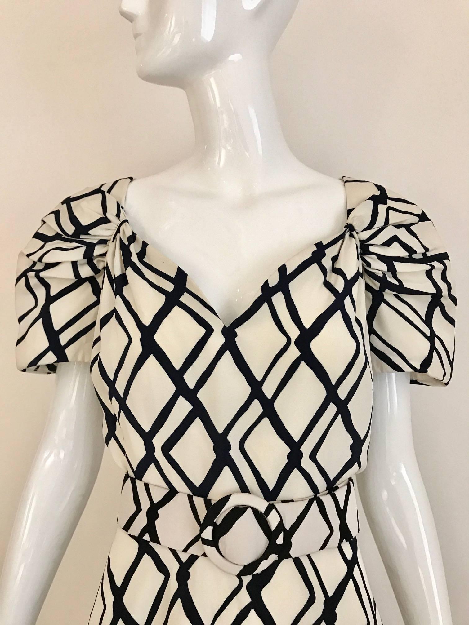 Vintage 1990s Arnold SCAASI boutique Creme and black Checkered Print Cocktail Dress with sweetheart neckline and flair skirt . Ruching sleeves and slightly puffy. Dress comes with matching belt.
Size: Medium- Large  / 6/8
Bust: 40 inch/ Waist: 30