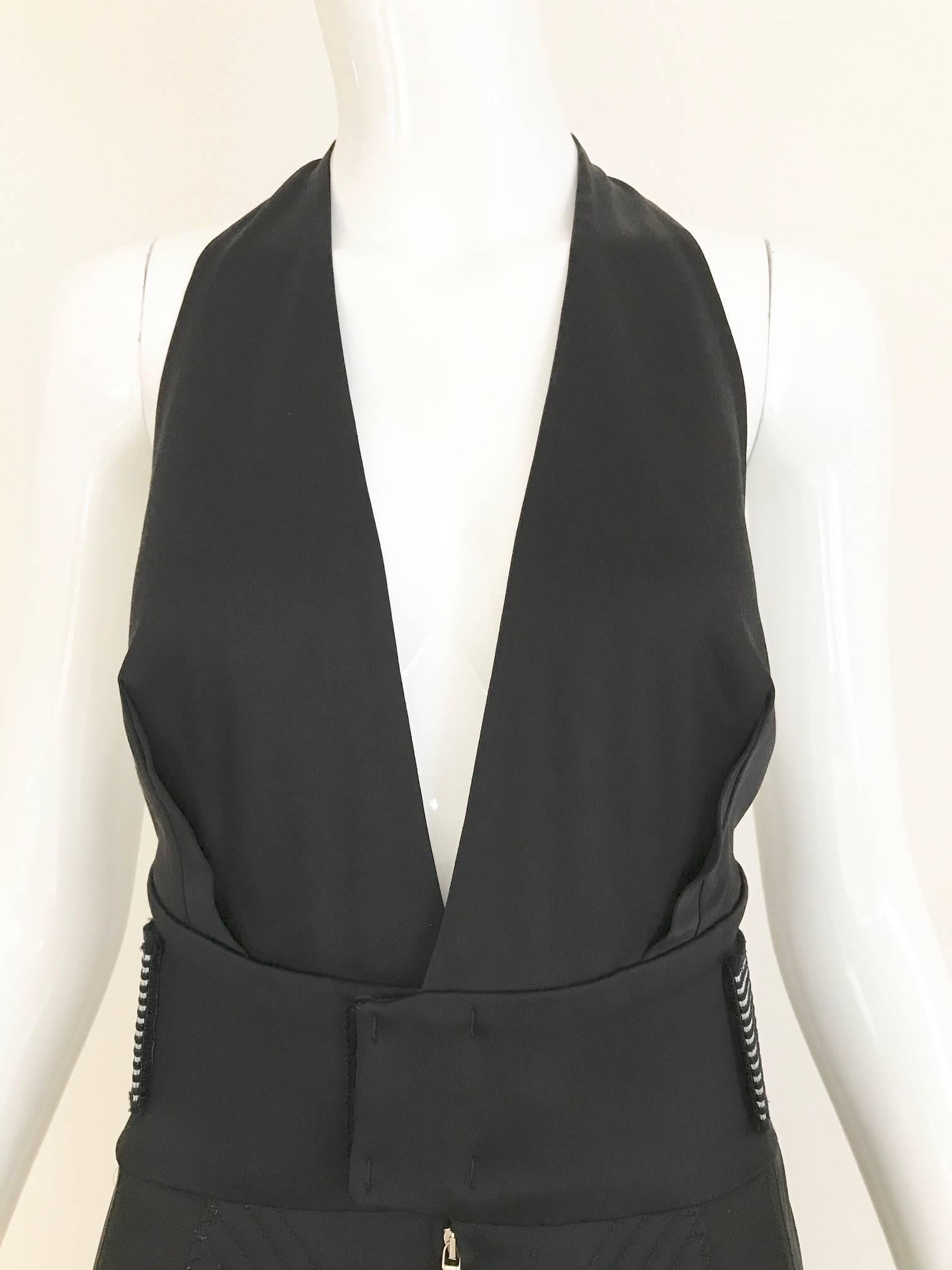1990s Jean Paul Gaultier Fitted Black Halter V neck Dress. Front zipper with adjustable velcro belt at the back. Dress has some strecth. Fit size 2/4 Small
Bust: 32 inch - 34 inch
Waist: 26 inch / Hip: 34 inch/ Dress length: 40
**** This Garment has
