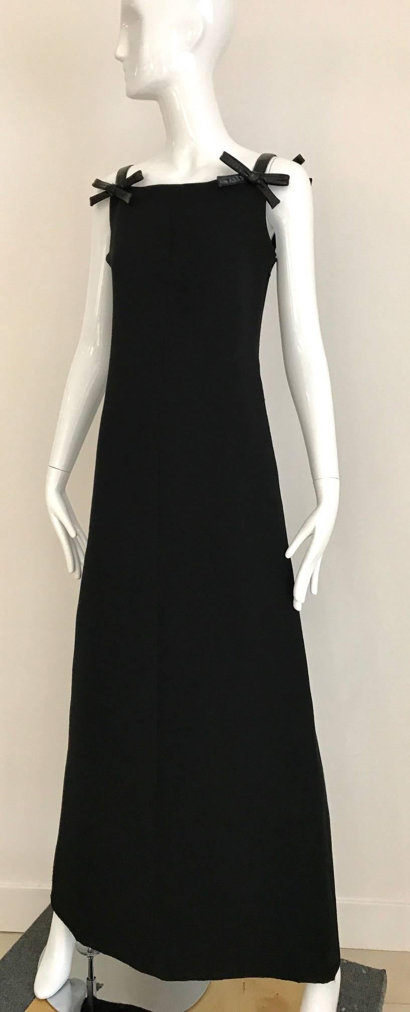 Modern and simple Vintage 60s Black Courreges Paris Maxi Dress with Patent leather 2 bows straps. Long slim line and slightly A line. Zip on the side and bows has hooks an eye to fasten.  Dress is lined in silk.
Fit Size US 6/ Medium
Bust: 34 inch /