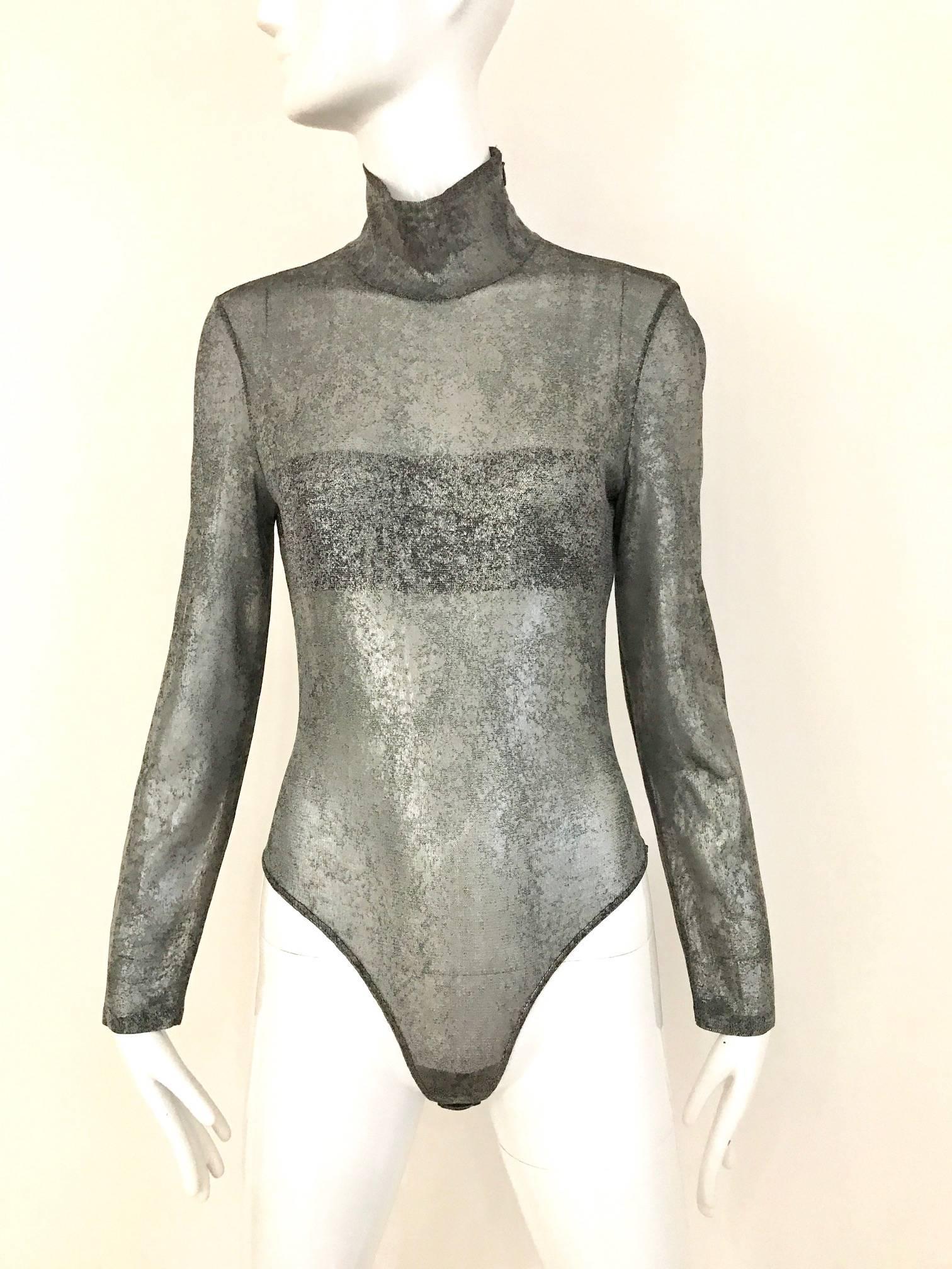 1980s GIANFRANCO FERRE Silver Grey Metallic long sleeve  mock neck bodysuit. Zip on the side.
Fit size Medium ( stretchy)
Bust: 34 inch - 36 inch
Waist: 26 inch - 28 inch / hip: 30 inch - 34 inch / Length 26 inch
**** This Garment has been