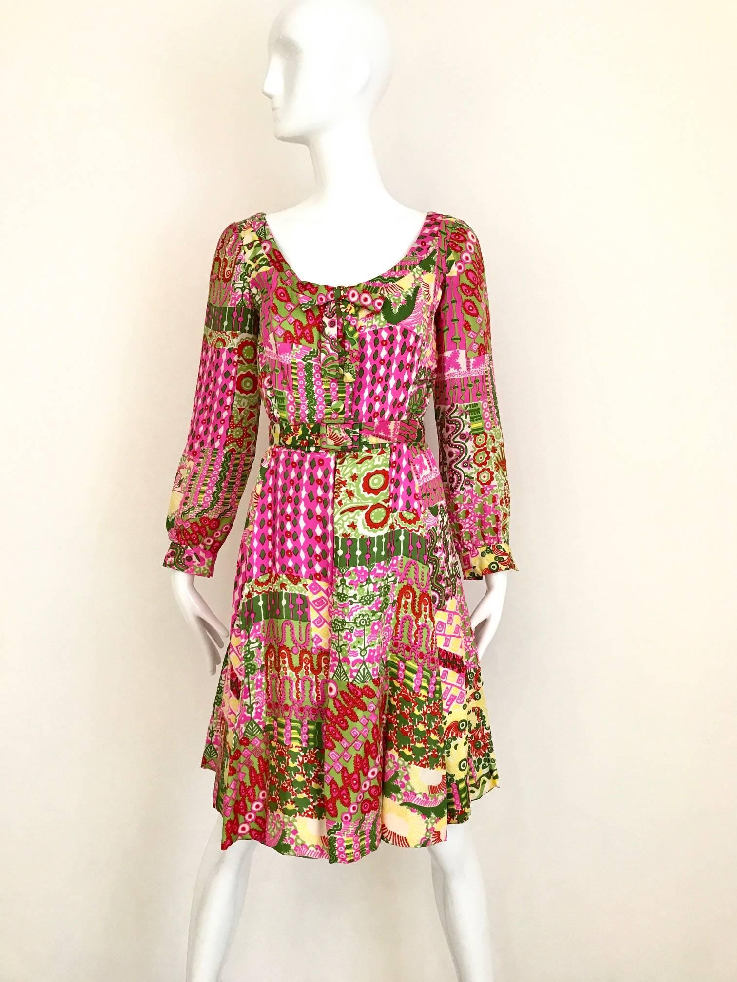 Vintage 1960s Pink, Green and yellow Vibrant Psychedelic Paisley Print Silk 60s Dress featuring scoop neck and covered silk button with belt. Slightly A line skirt.
Bust: 34 inch / Waist: 26 inch / Length: 38 inch
**** This Garment has been