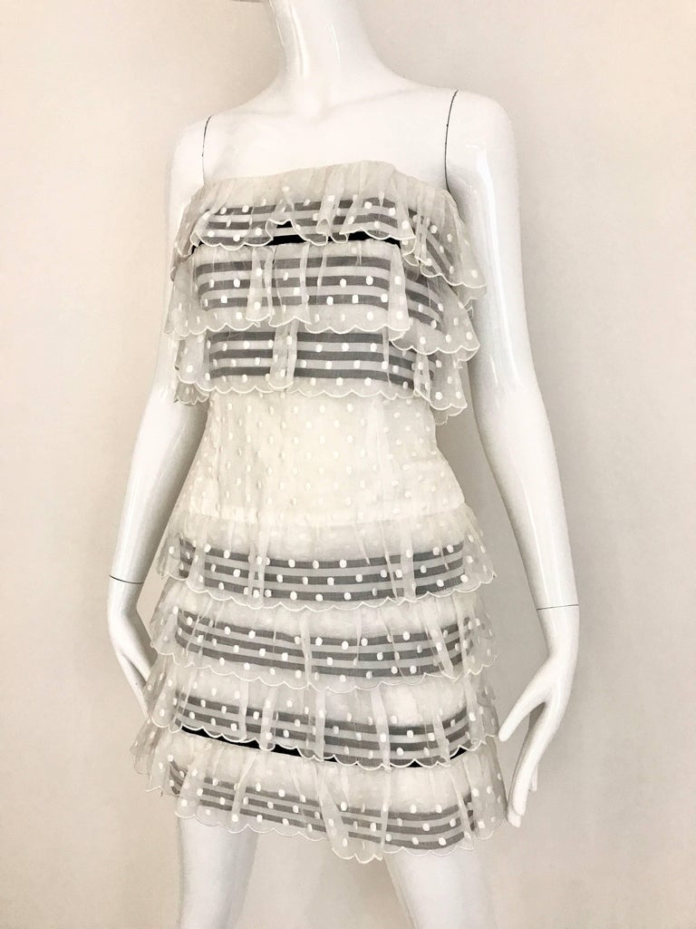 What a fun CHANEL Party Dress! Strapless CHANEL dress in white cotton swiss dot. Black and white stripe ribbon band on the bodice and skirt. Form fitting and very flattering cut. Fit US 4 
Bust: 34 inch / Waist: 29 inch / Hip: 34.5 inch  / Dress
