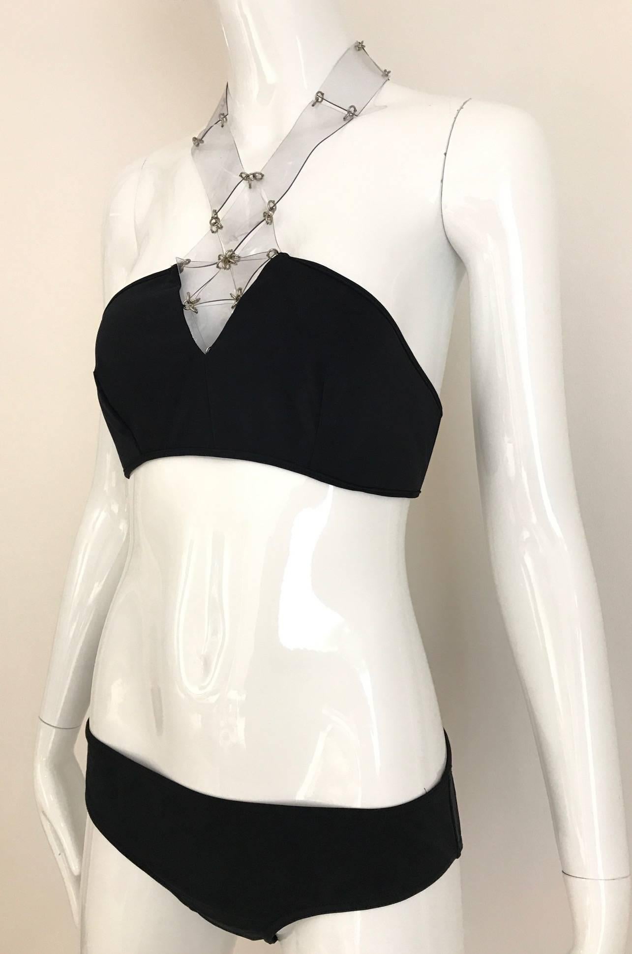 Unworn Paco Rabanne Black Halter Bikini top with clear plastic cut out.
Fit Size 4
Bust: 32 inch to  34 inch bust 
Bikini size: 34 inch 