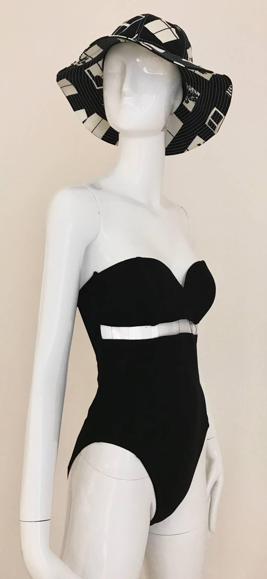 UNWORN PACO RABANNE Black One Piece swimsuit/ bathing suit with cutout clear plastic. Work well as body suit. Swimwear is style with vintage Chanel Hat available at my 1stdibs store. 
Fit size 4
Measurement: 
Bust: 32 - 34 inch / Waist: 28 inch /