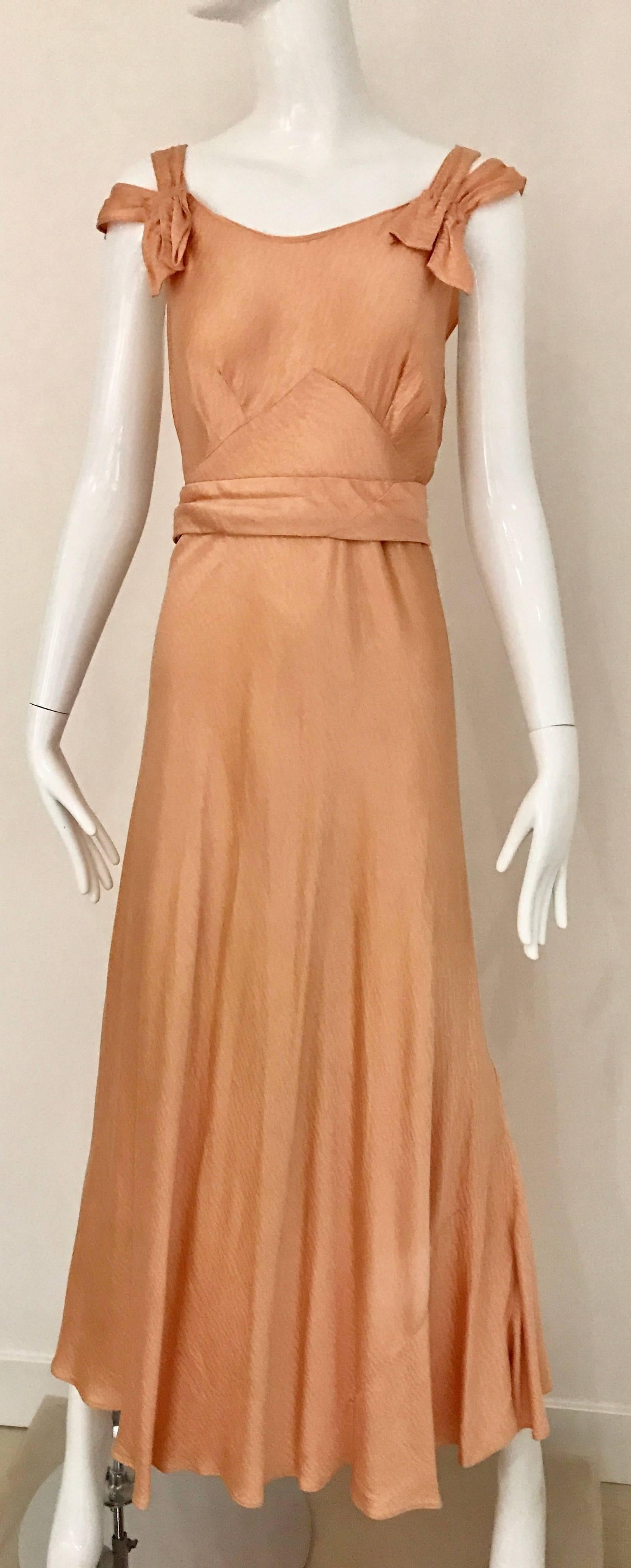 Beautiful 1930s peach silk spaghetti strap bias cut dress with trains at the back. Dress comes with capelet shawl. 
Dress fit size 2/4 small
Cape fit size 4/6
**small stains see image attached