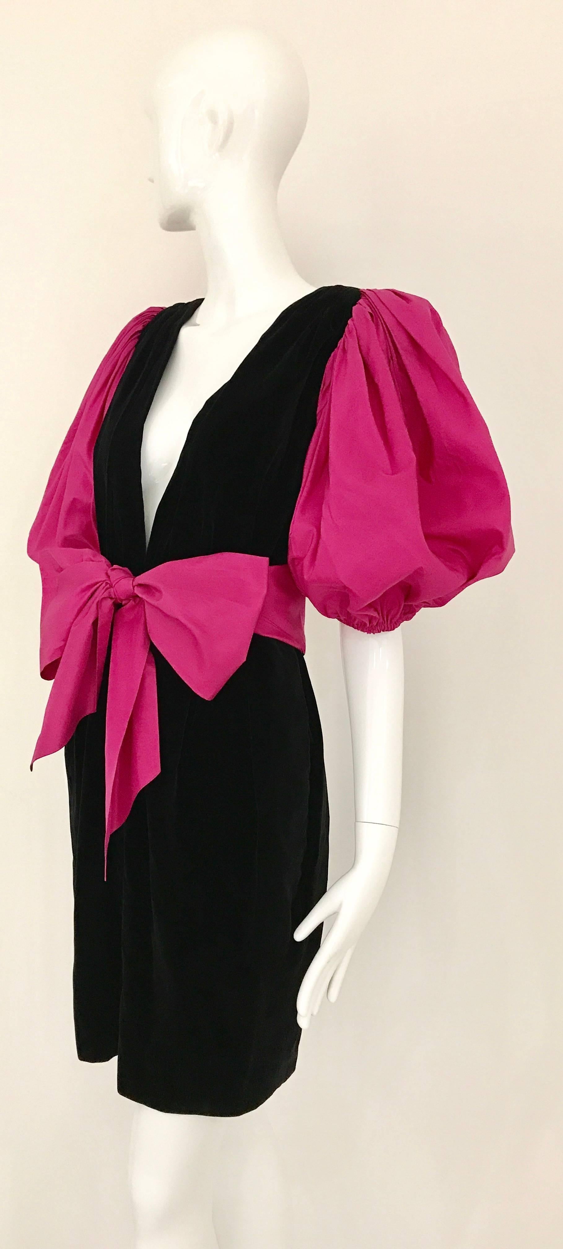 Vintage Yves Saint Laurent creation from 1980s! Black Velvet Dress with plunging neckline with beautiful Schiaparelli Pink puffy sleeves. Silk Ribbon sash and zipper on the side. Truly Collectors item. Size: Small or US 4
Bust: 34 inch - 36 inch /