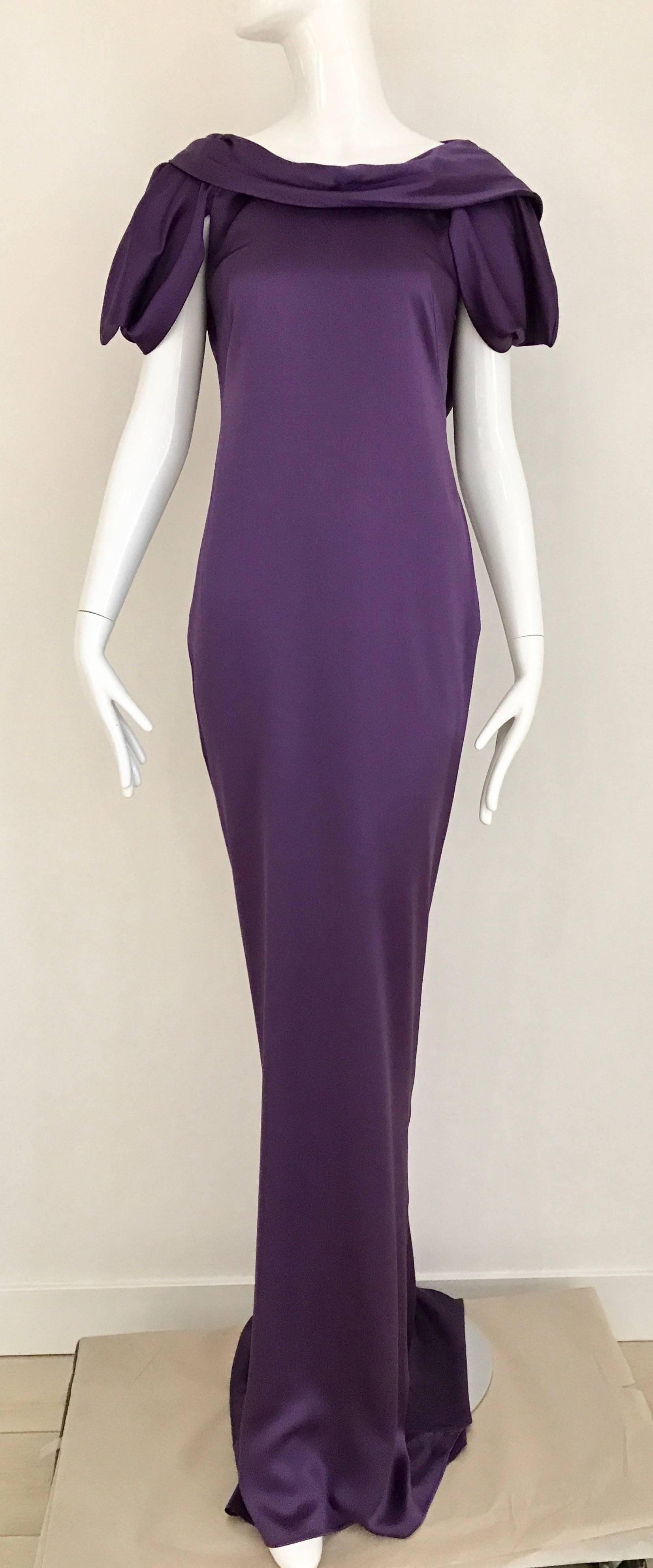 Stunning Alexander McQueen Purple violet silk charmeuse gown with interesting sleeves and exposed bare back. Slightly cowl neck. strap can be removed. Dress zip from the side. Size Medium / 6

Bust: 36 inch ( back is open) / Waist: 30 inch
Hip: 36.5