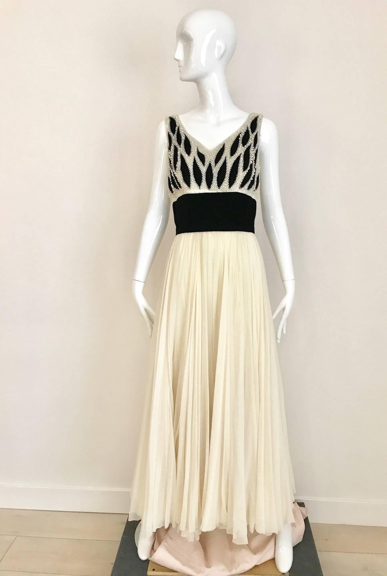 This vintage Phillip Hulitar 1950s, ivory silk chiffon and black velvet cocktail dress is the perfect party dress or great for wedding. Gown has intricate black velvet, ivory silk chiffon, pearl encrusted, leaf-motif bodice and its double-layer,