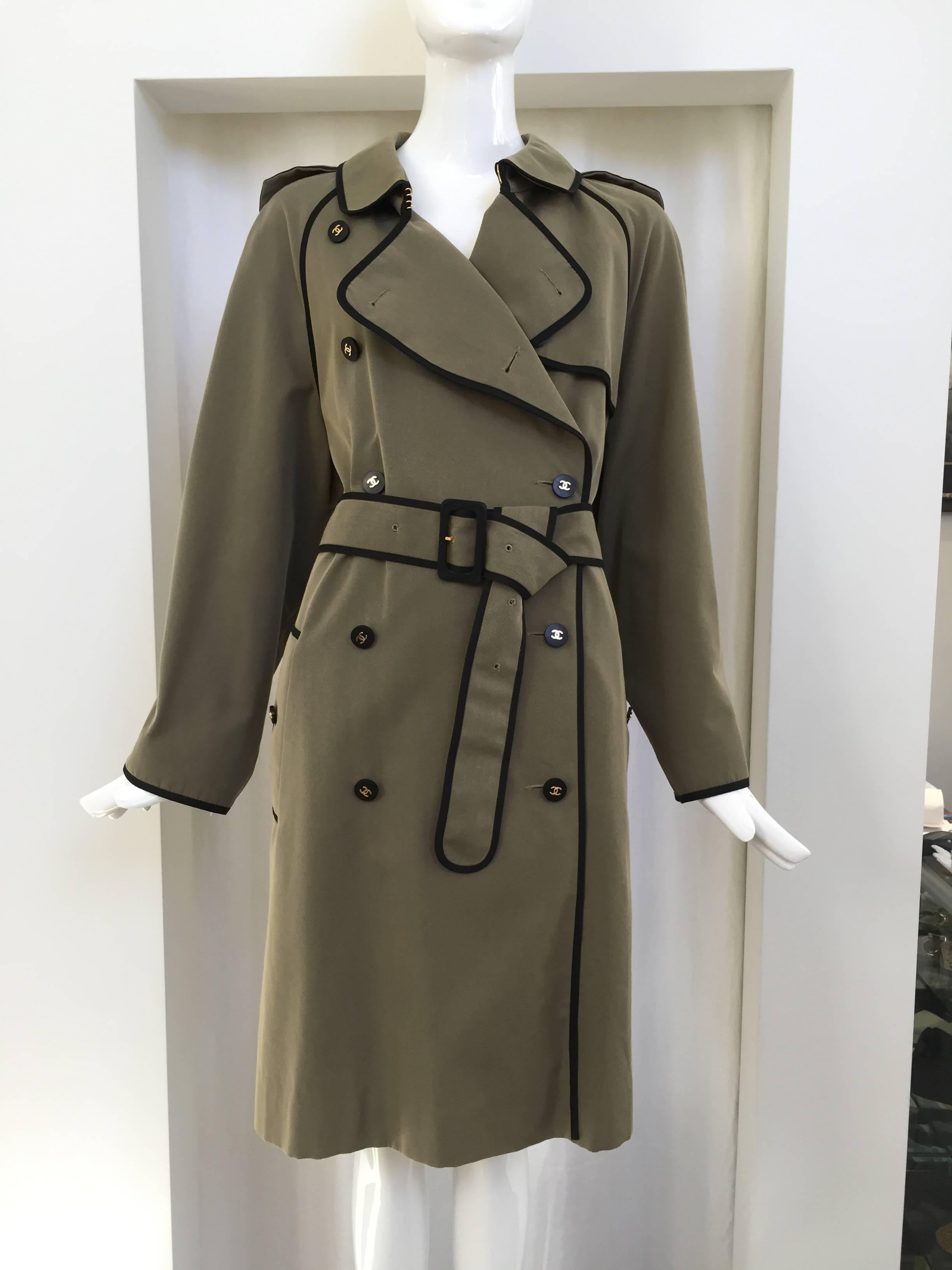 Beautiful Olive green cotton Chanel Trench coat with black piping. Chanel button. 2 pockets. Belt. Size :46  Fit best : US 8/10/12
Measurement is taken when coat is buttoned. Bust: 48"/  Waist: 48" / Hip: 54"/ Trench length from