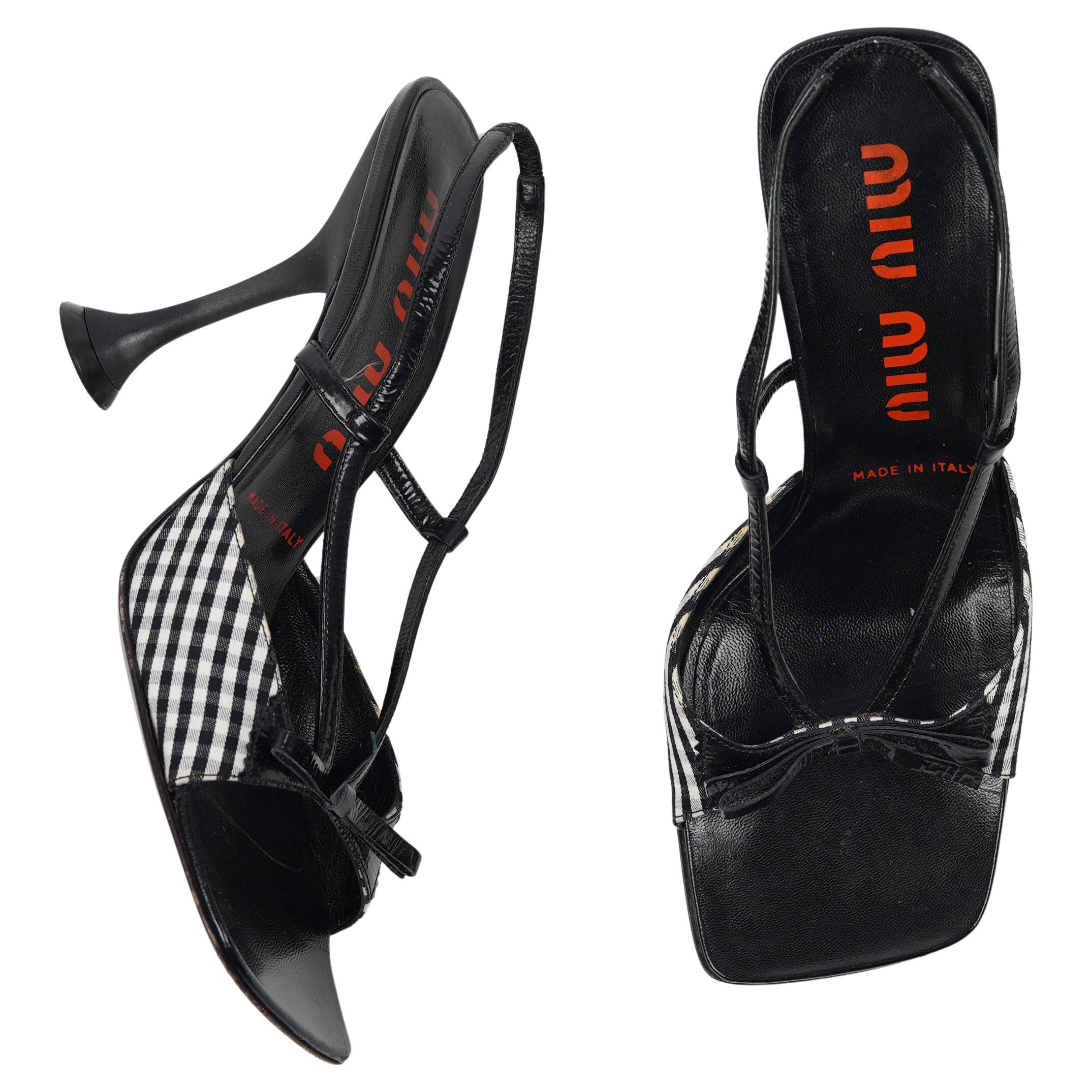 Presenting the F/W 1999 Miu Miu black and white gingham checkered T-strap heels. The Miu Miu Fall/Winter 1999 collection quickly gained high critical acclaim for its fashion forward-thinking designs and sheer density of new ideas exhibited on the