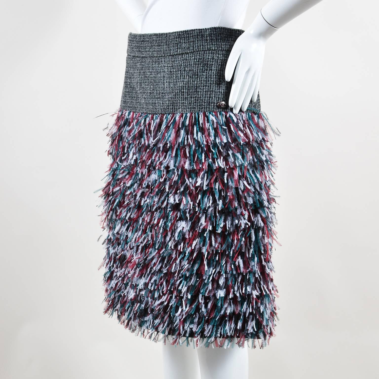 Retails at $7210. New with tags.
Gray and black tweed wool yoke. Maroon, forest green, white, and black ostrich feather fringe. Silver-tone metal and red enamel oval 'CC' plate at yoke. Concealed back zip and hook-and-eye closures. Lined.