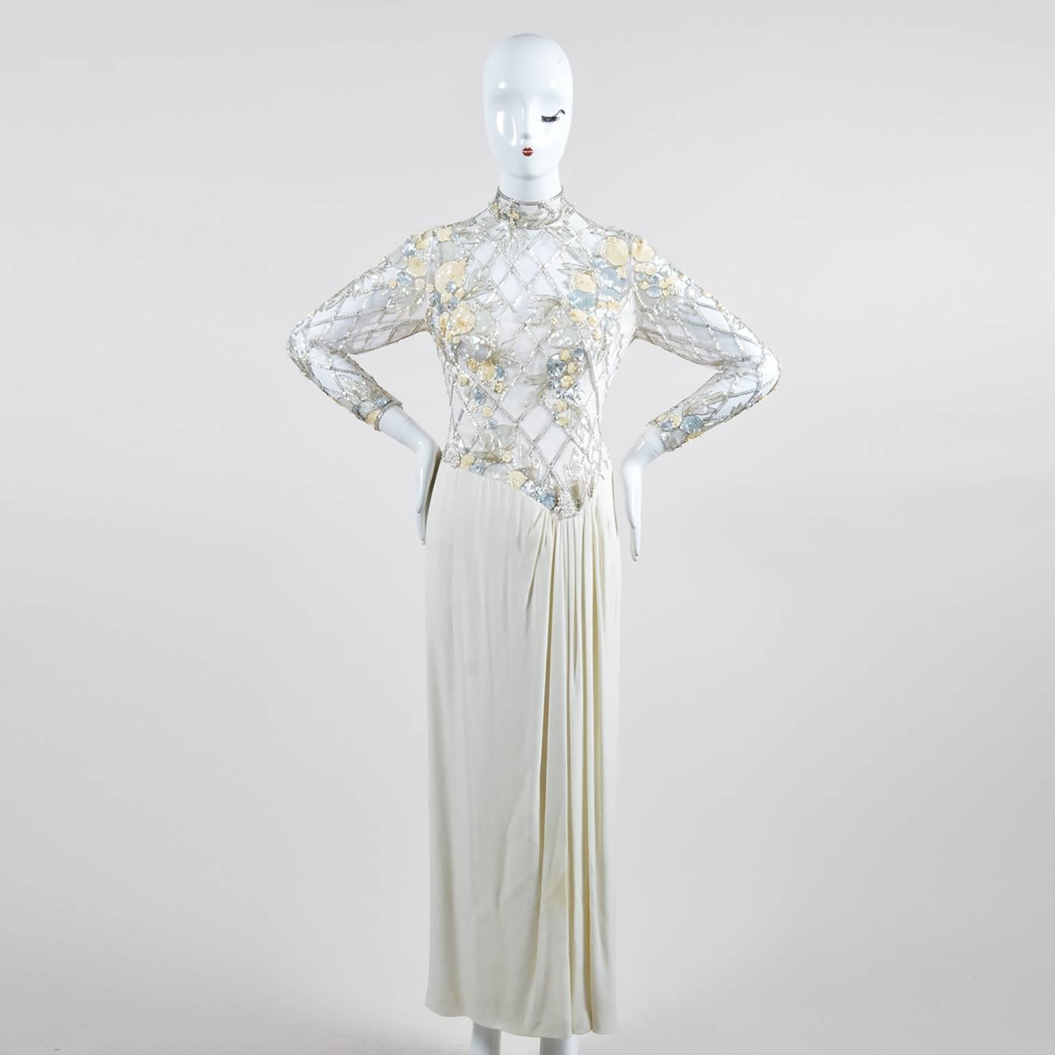 Vintage Bob Mackie maxi-length high-neck gown in white. Features a mesh bust and sleeves, an embellished bodice, and pleated front. Embellishment is composed of pearls, crystals, tonal/iridescent/silver-tone sequins, and cylinder beads. Sleeves