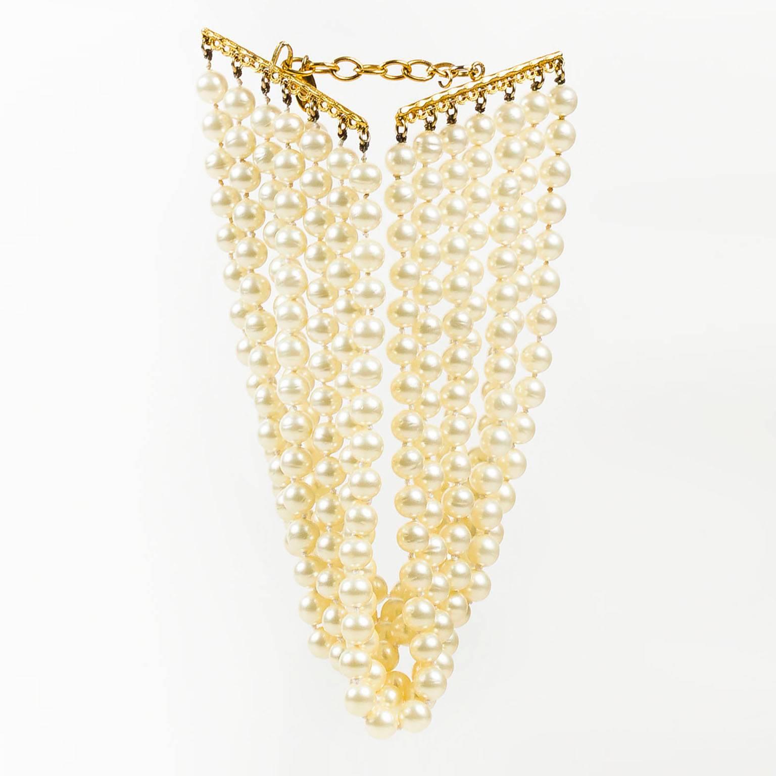 Vintage Chanel choker necklace. This classic piece emulates the sophisticated aesthetic of timeless brand. Add to any ensemble for instant upscale glamour. Multiple strands of faux pearls. Extender for adjustable sizing. Hook fastener.

Additional
