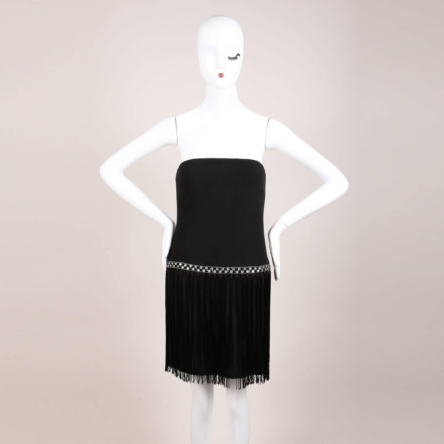This short black strapless dress features a very subtle sweetheart neckline with clear and black rhinestone and bead embellishment at waist.  Knotted fringe tassel trim from waist down skirt. Back zip fastening. Padded bust and boning bodice