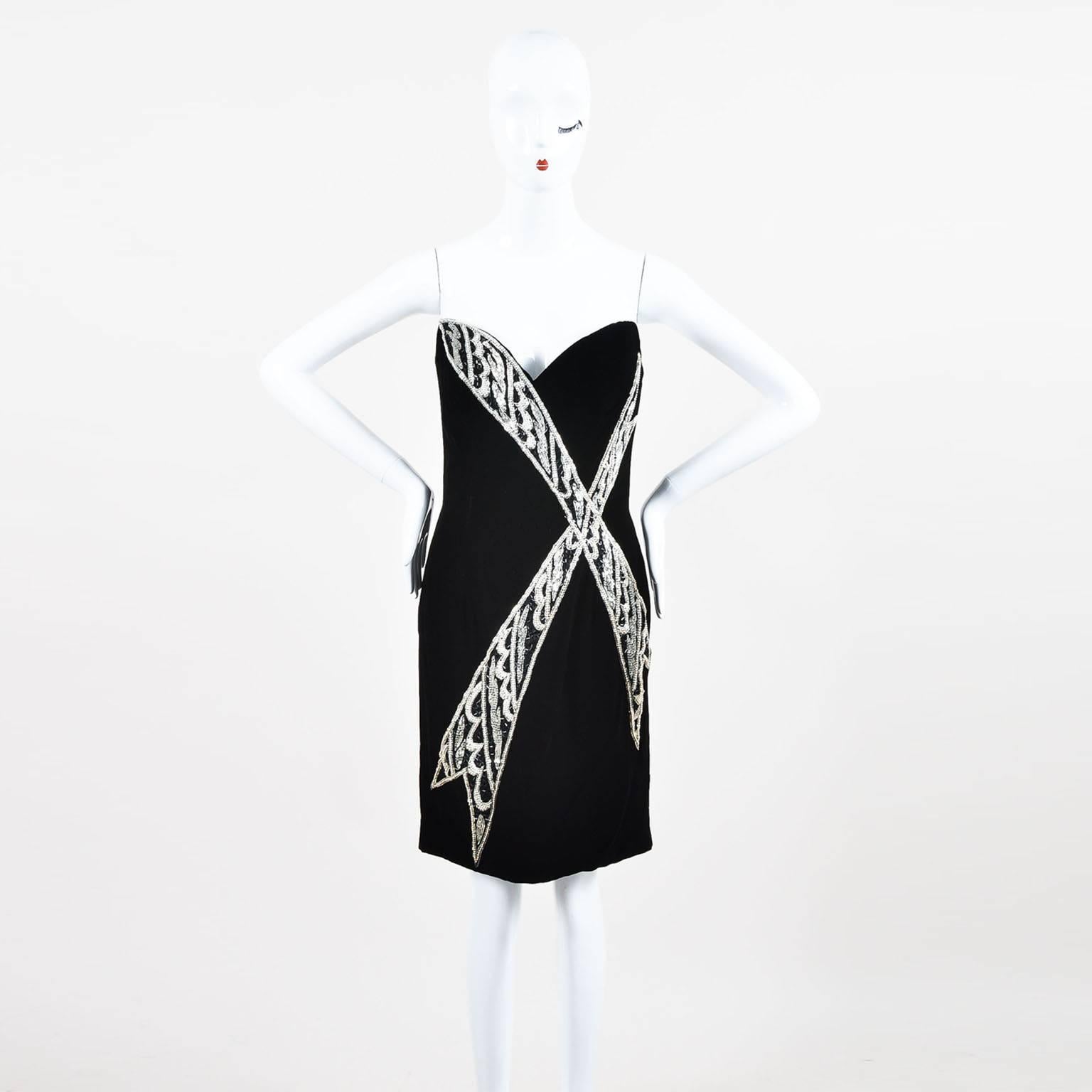 Vintage Bob Mackie strapless dress in black velvet. Features a feminine sweetheart bodice, hourglass silhouette, and crisscross embellishment at front. Embellishment is composed of black and silver-tone cylinders, and silver-tone beads. Softly boned